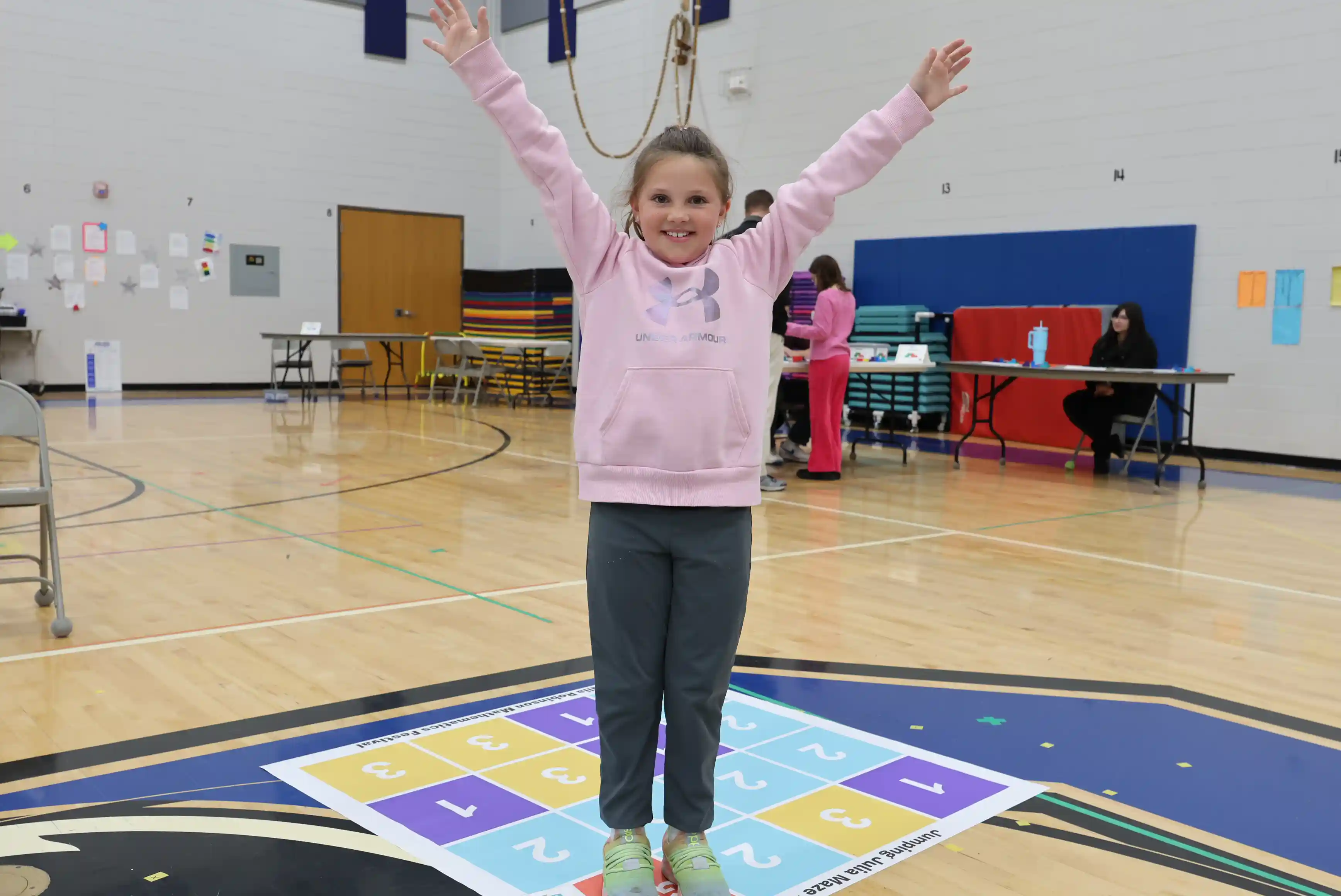 Student celebrating on top of a math chart
