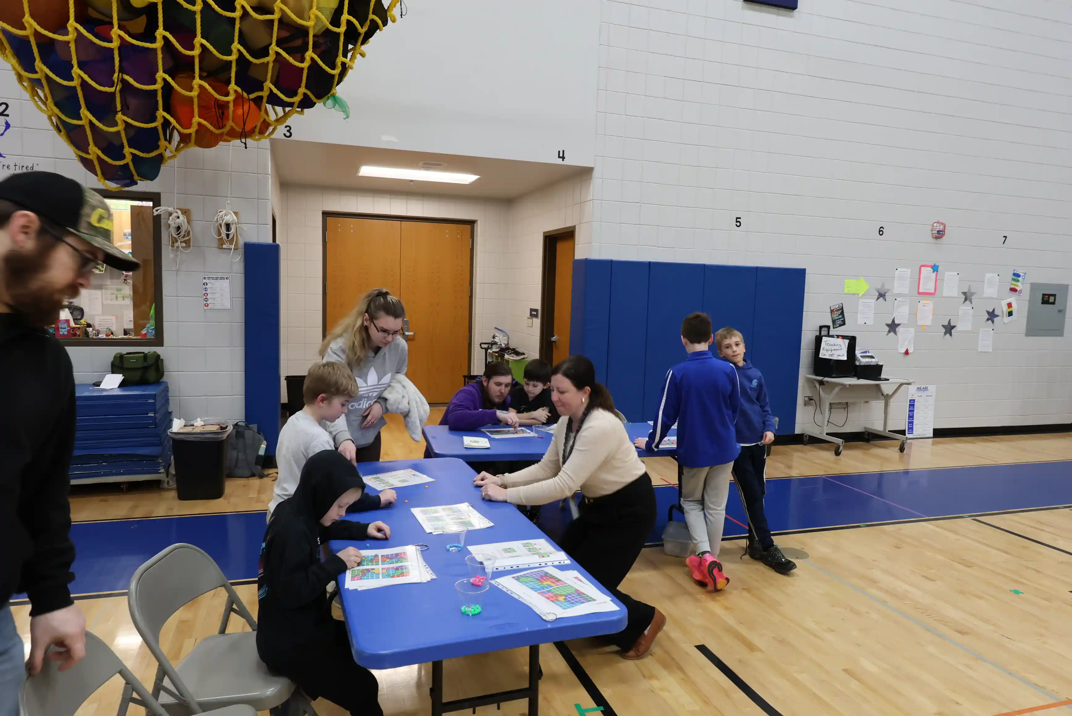 2 tables together with multiple students working on various math games