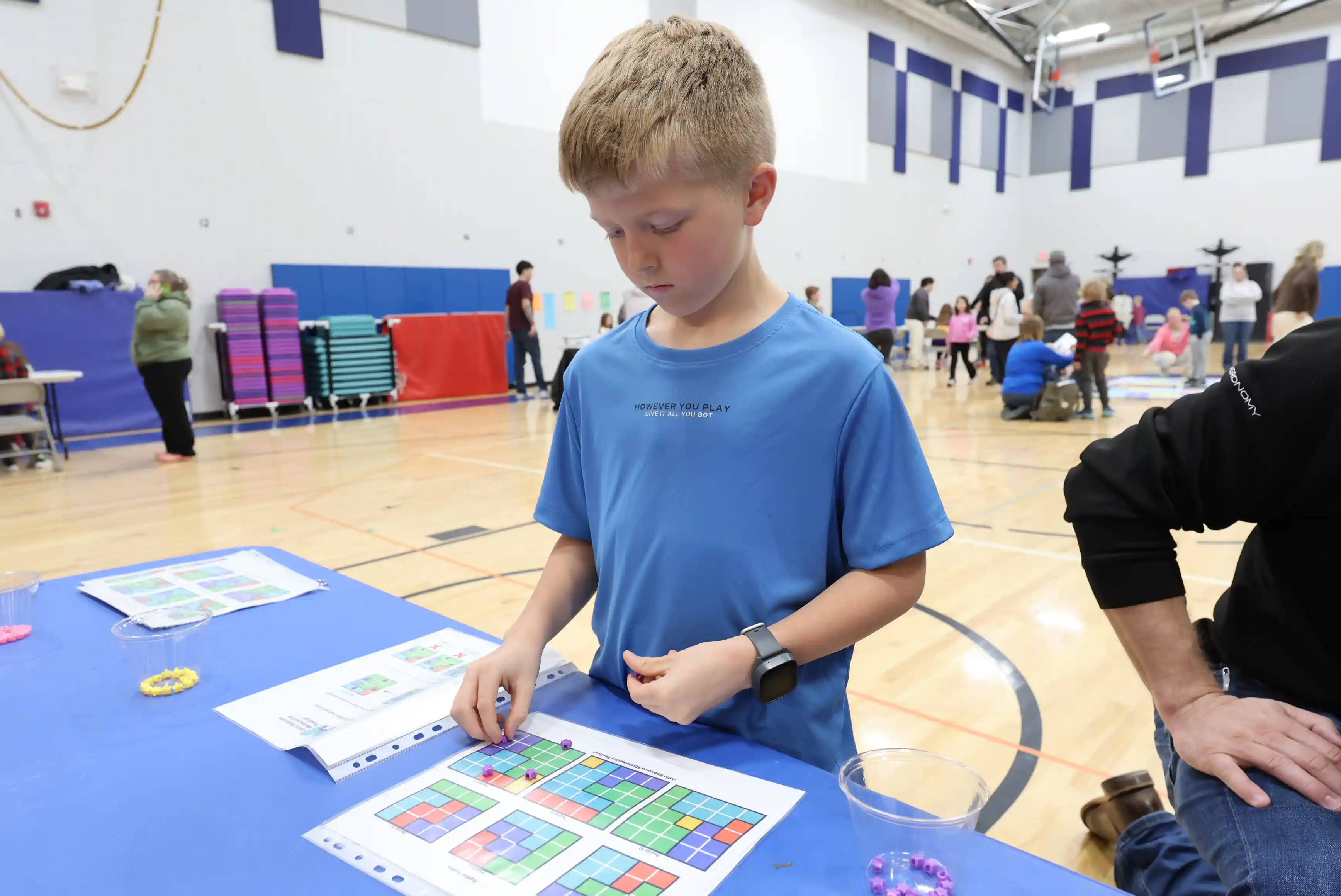Student working at a table solving a problem
