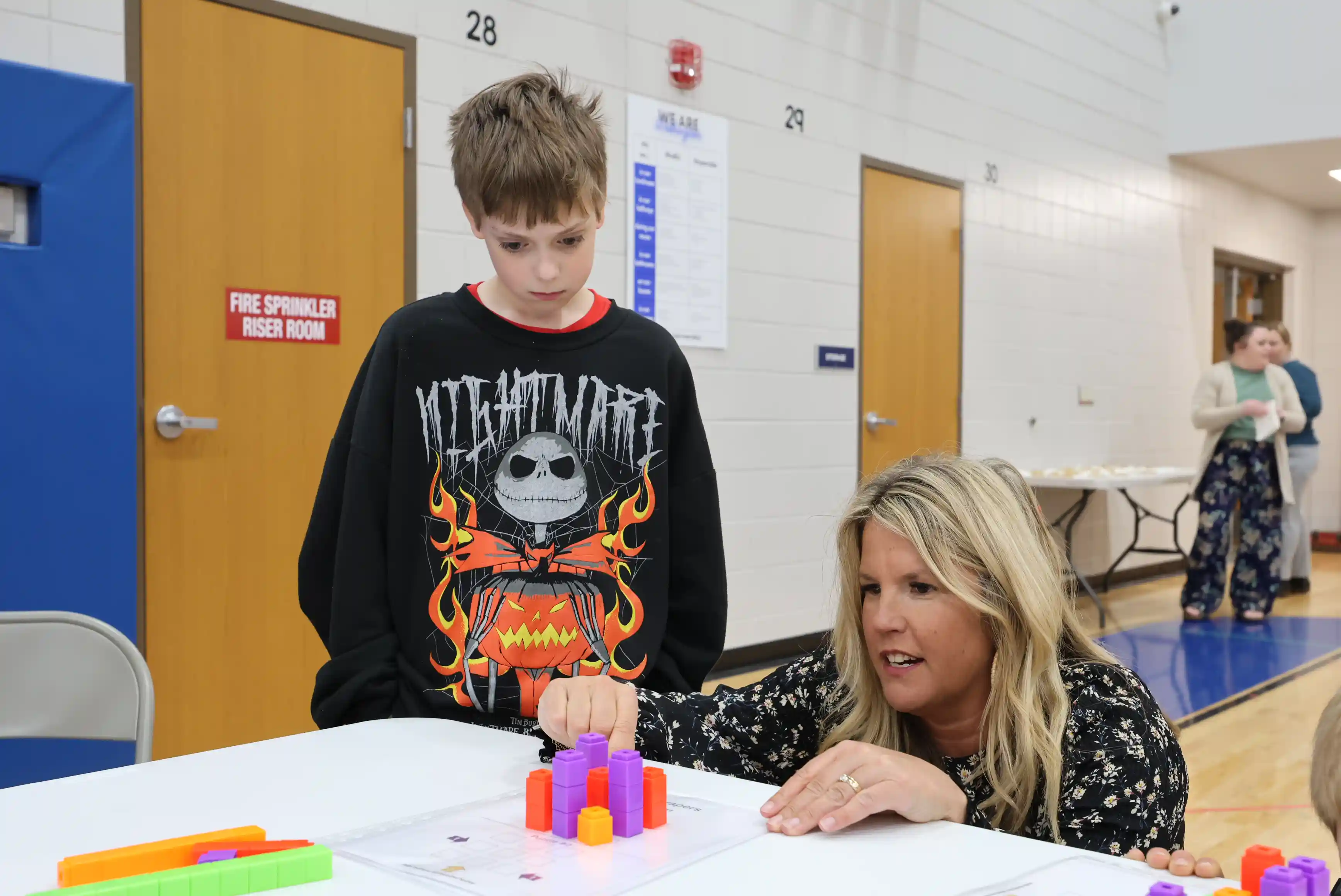 Student and SCSC Staff member working on stacking math problem