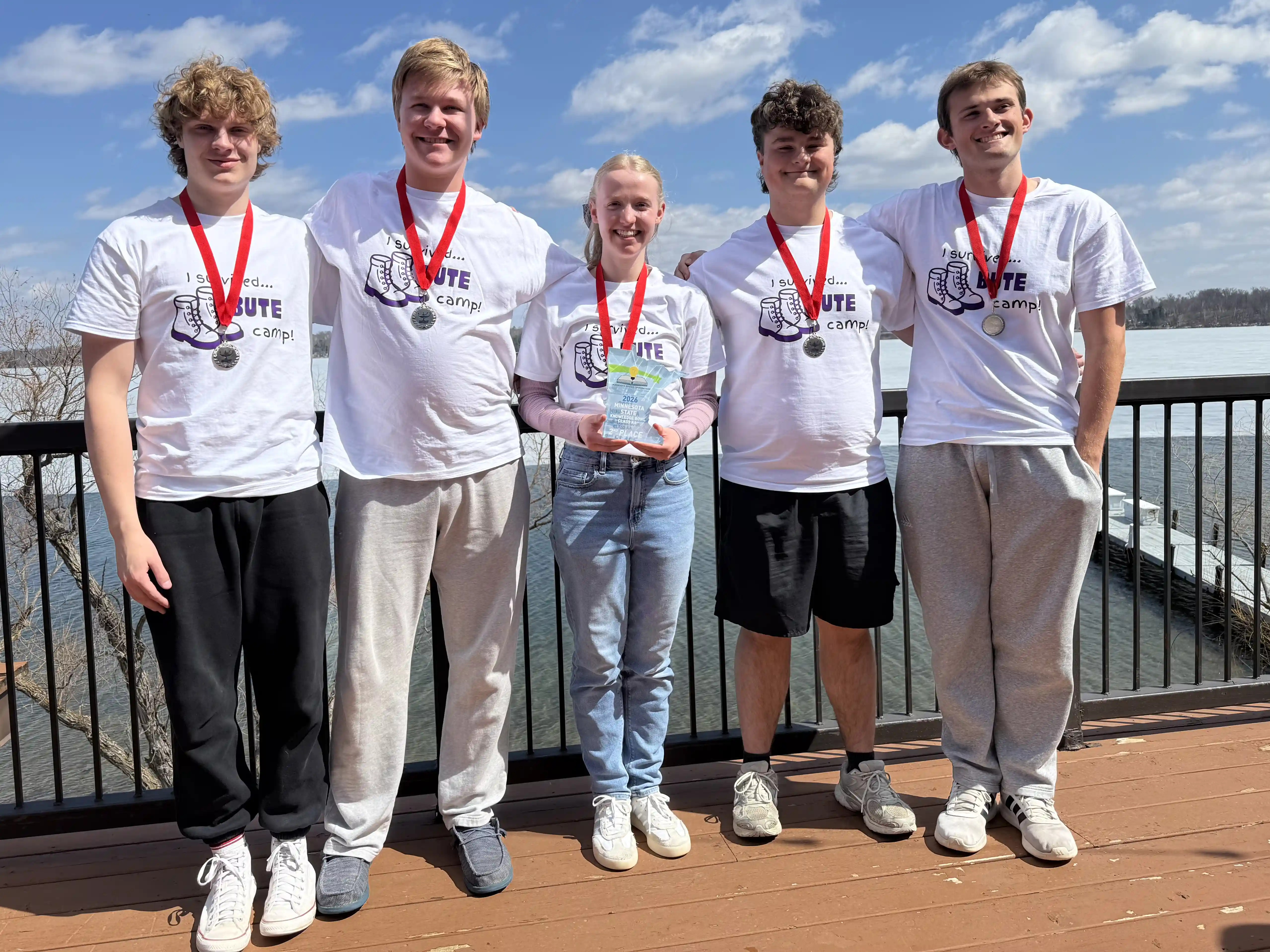 New Ulm Knowledge Bowl Team of 5 students wearing their medals and holding their award.