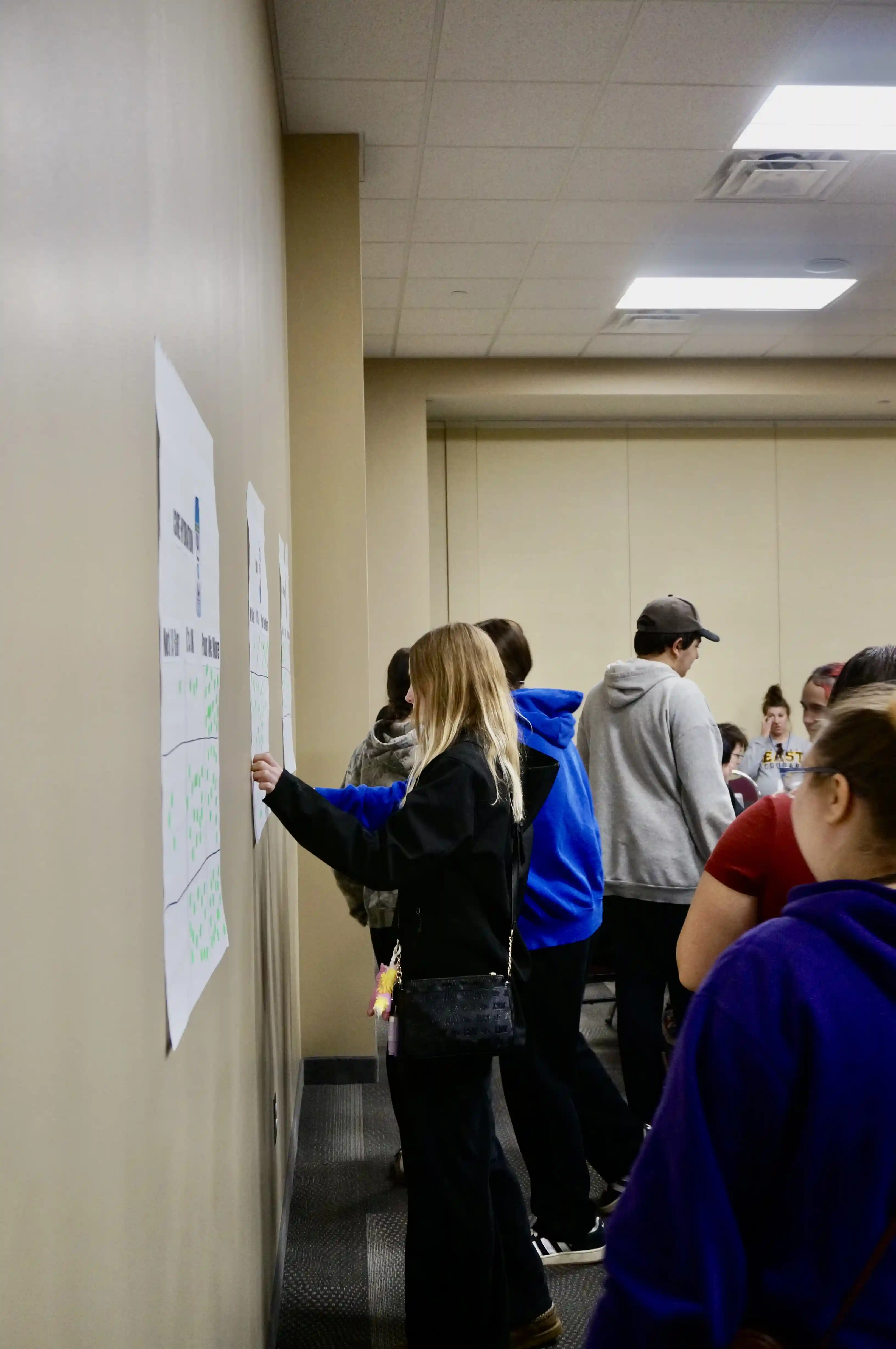 students going up to a paper and making a list.