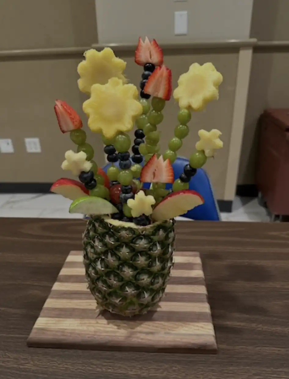 fruit made to look like flowers and a vase