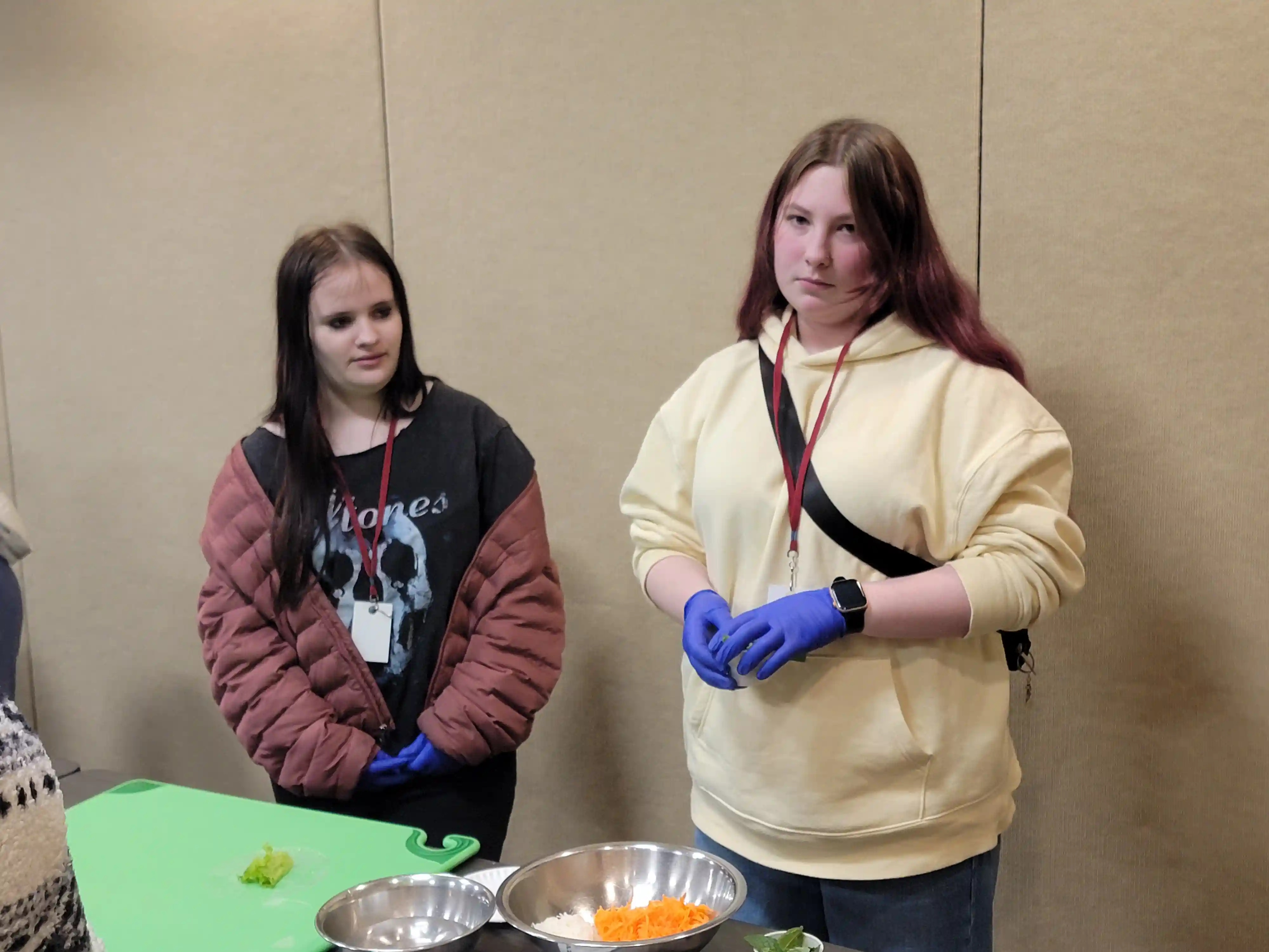 students at tables preparing food