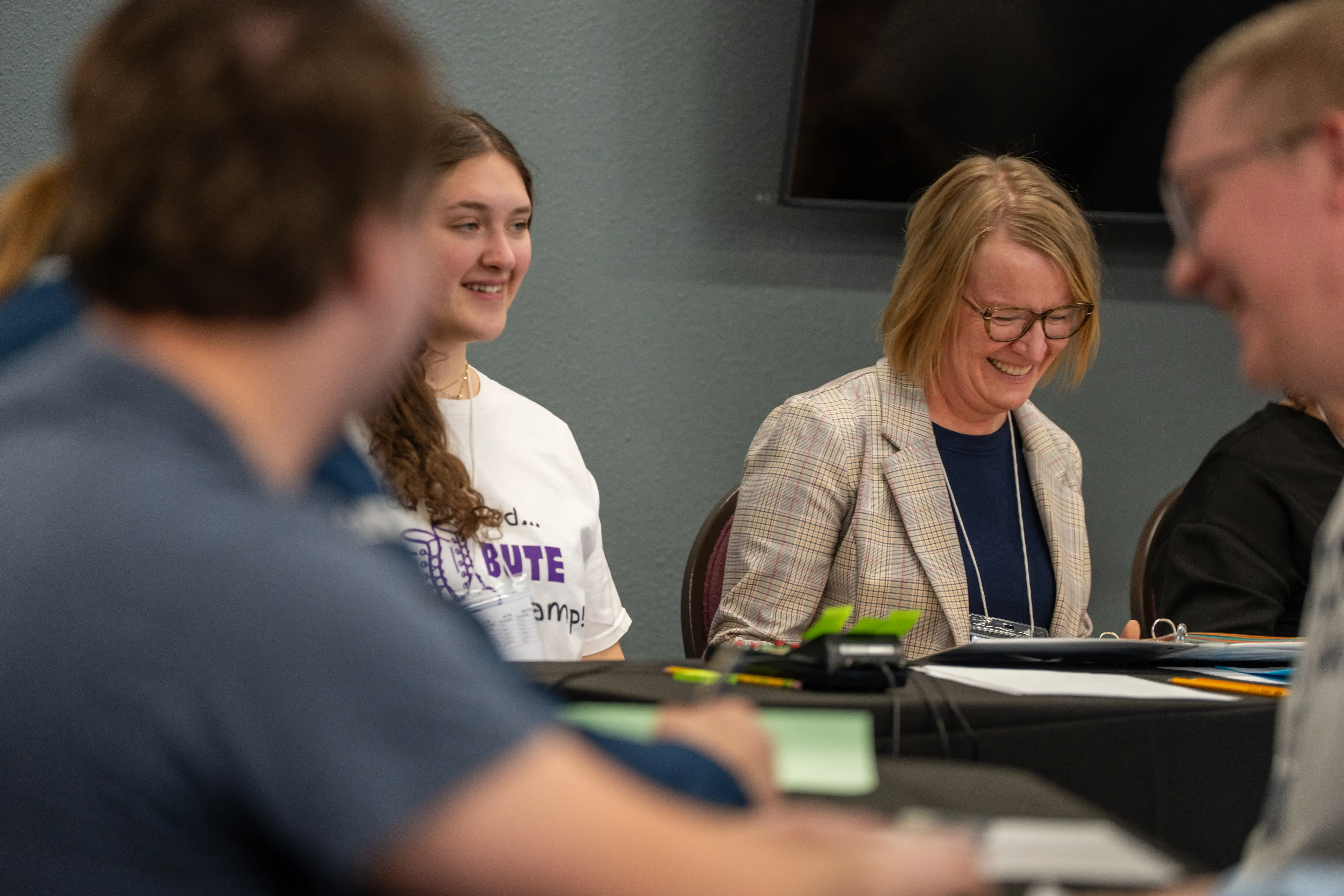 Students and adults at table