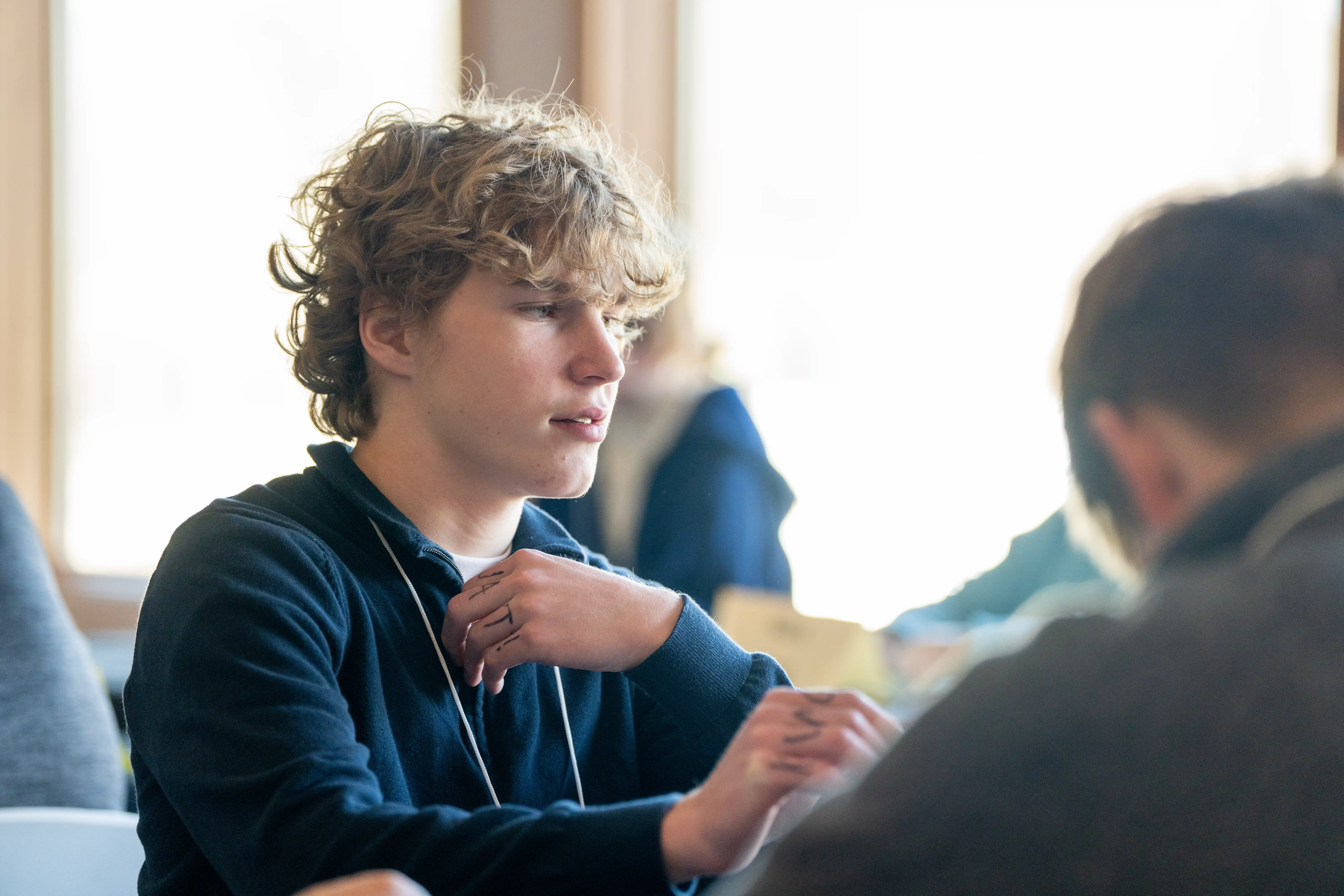 student sitting at table getting ready to do competition