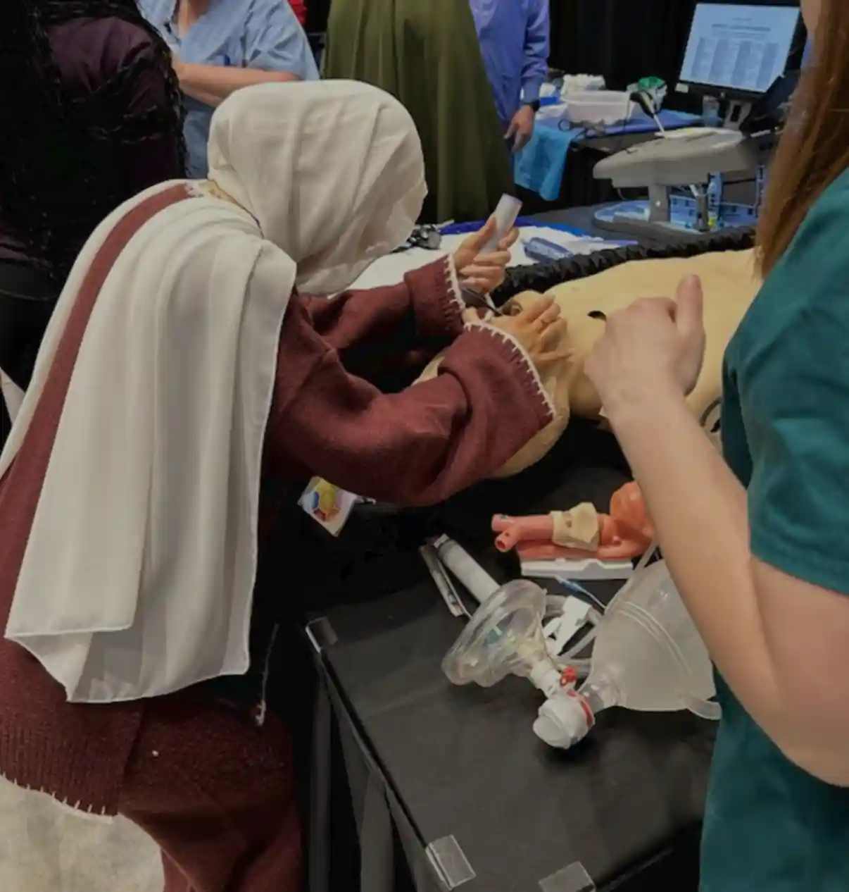 students learning how to insert a breathing tube in a dummy