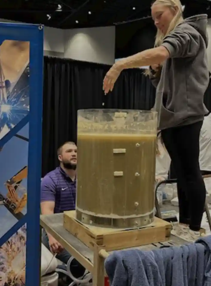 Students at a career booth putting their hand in a giant tube