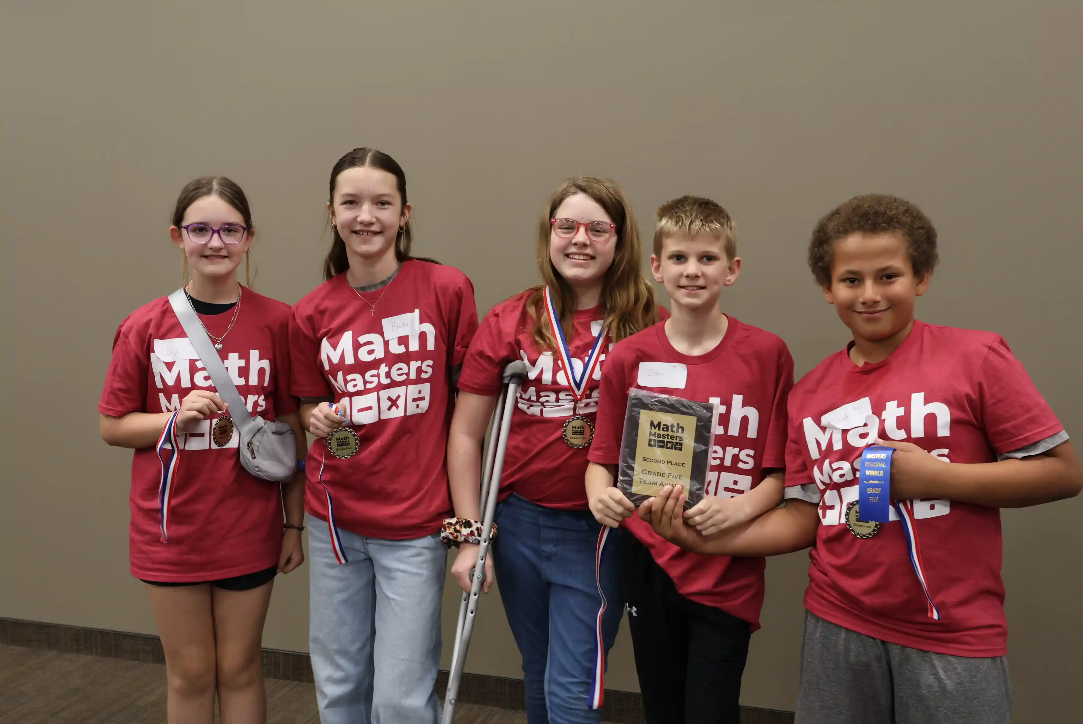 Students standing together holding their award