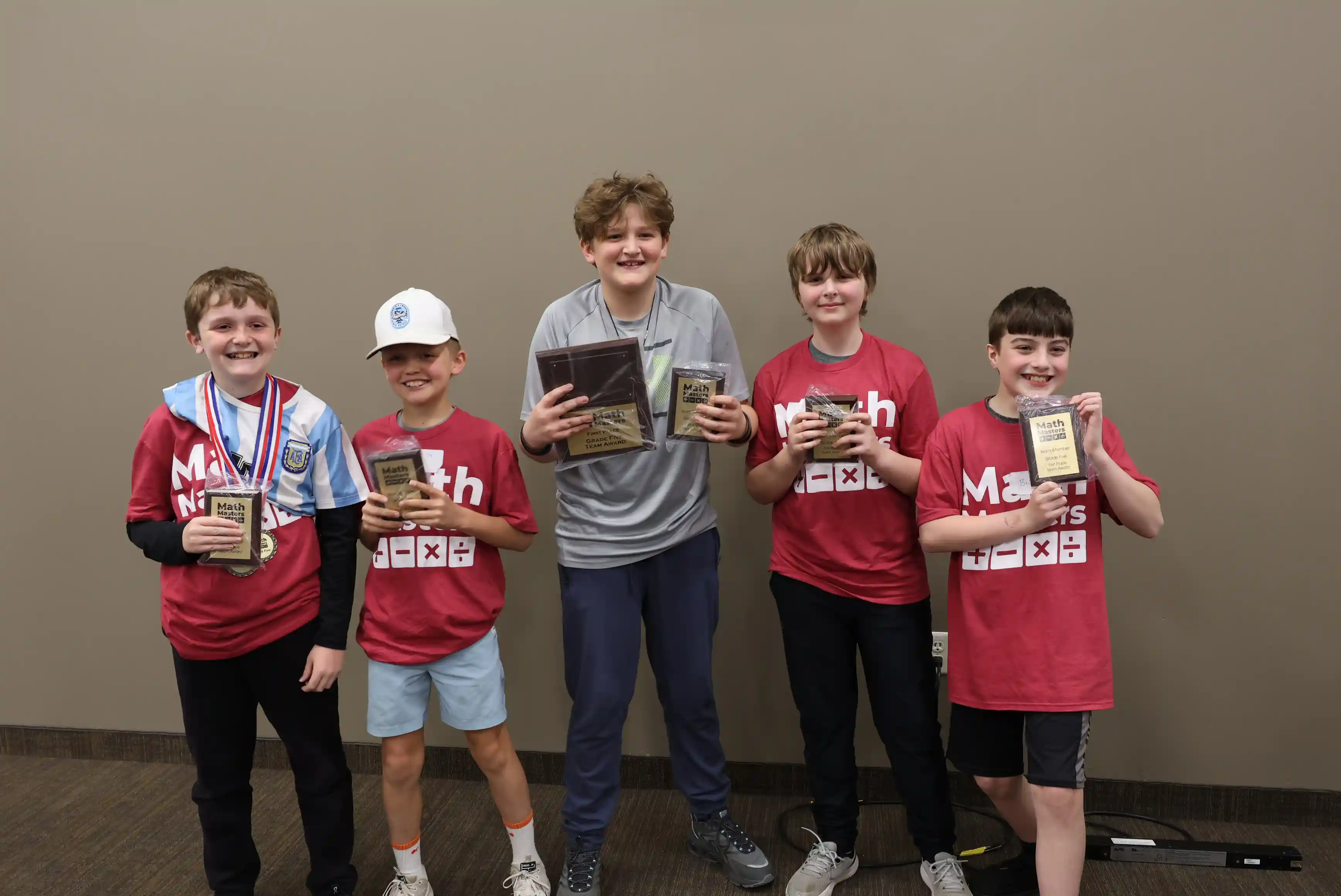 Students standing together holding their award