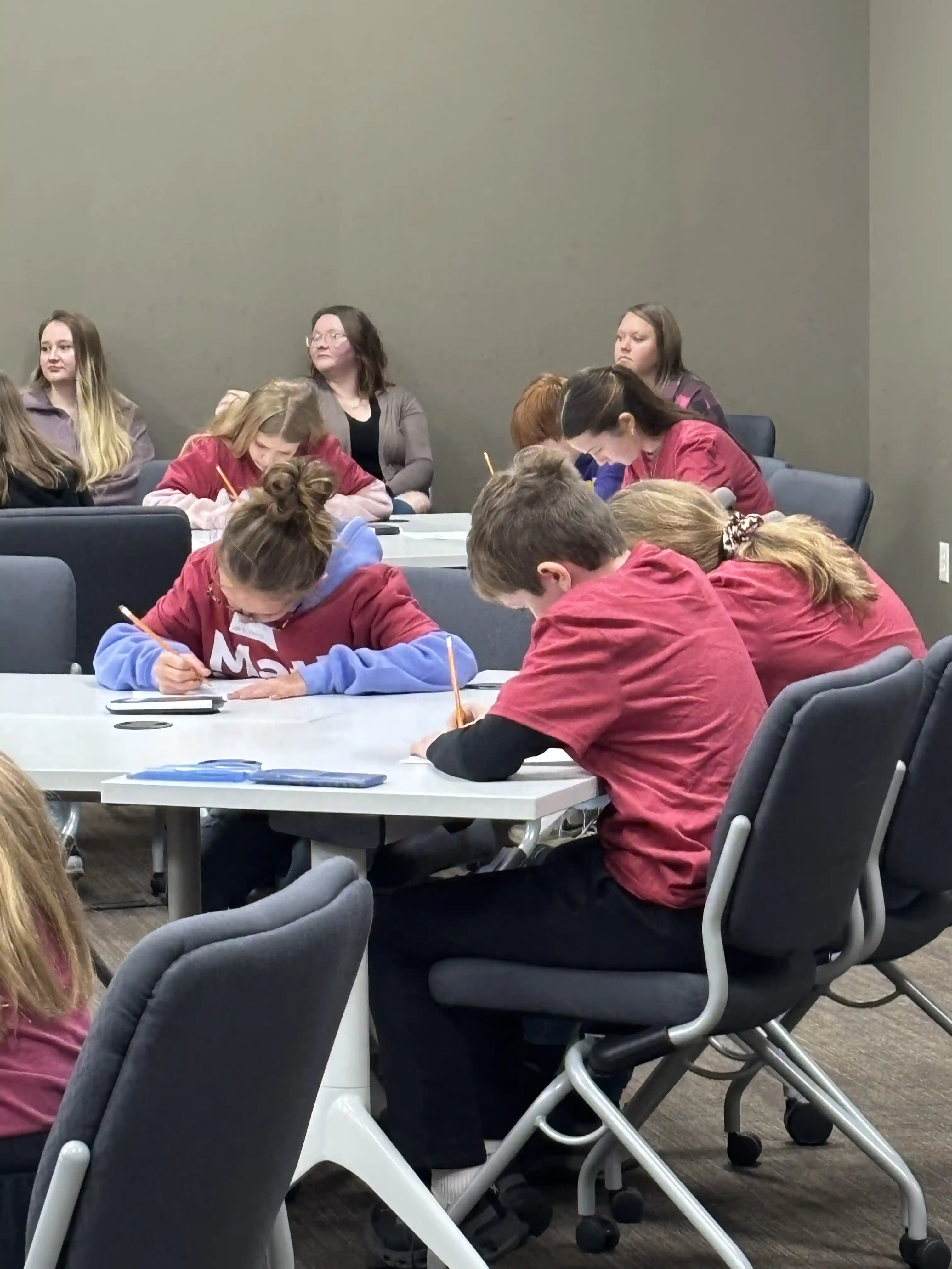 students sitting at tables working on their math problems