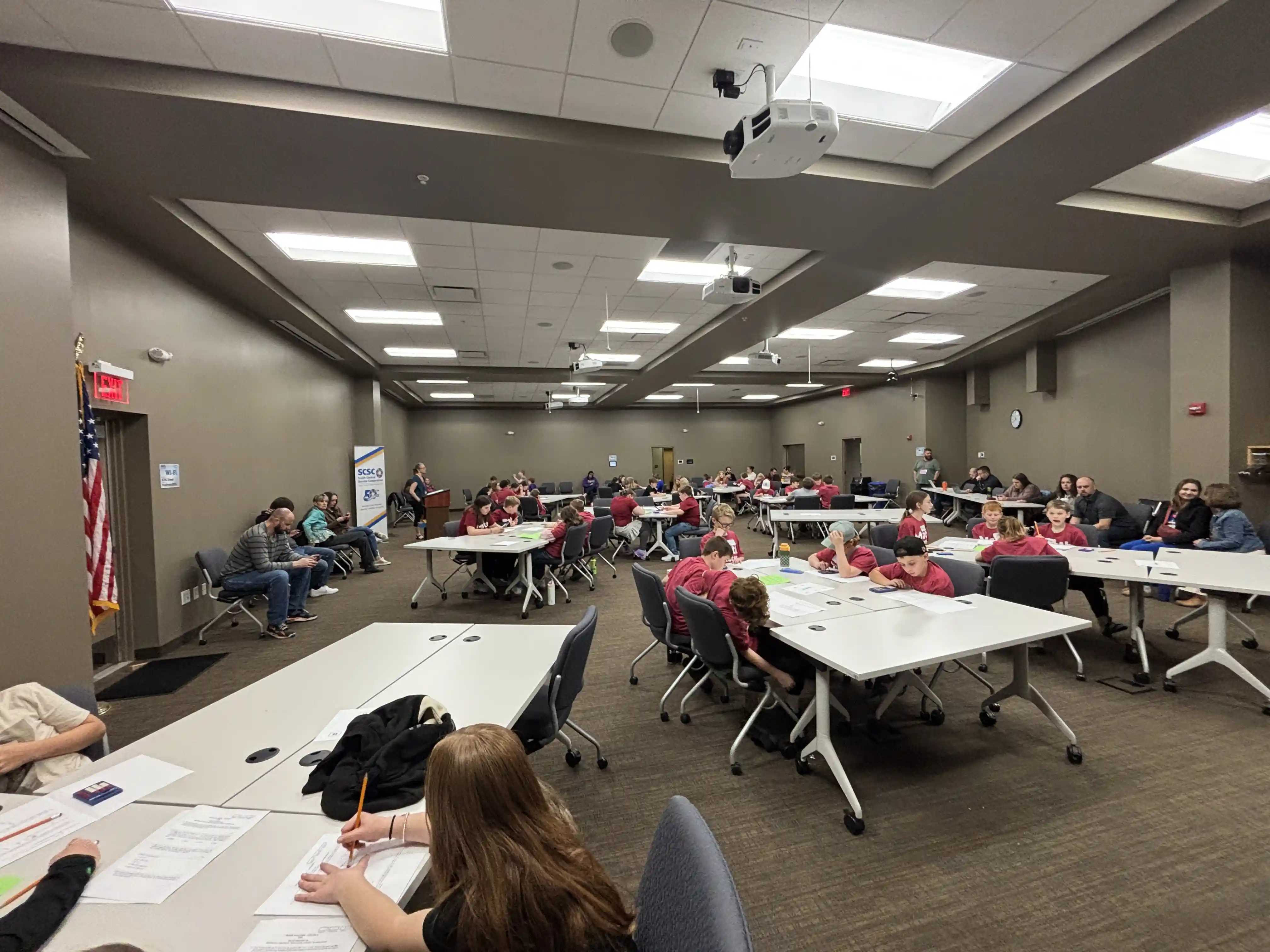 students sitting at tables working on their math problems