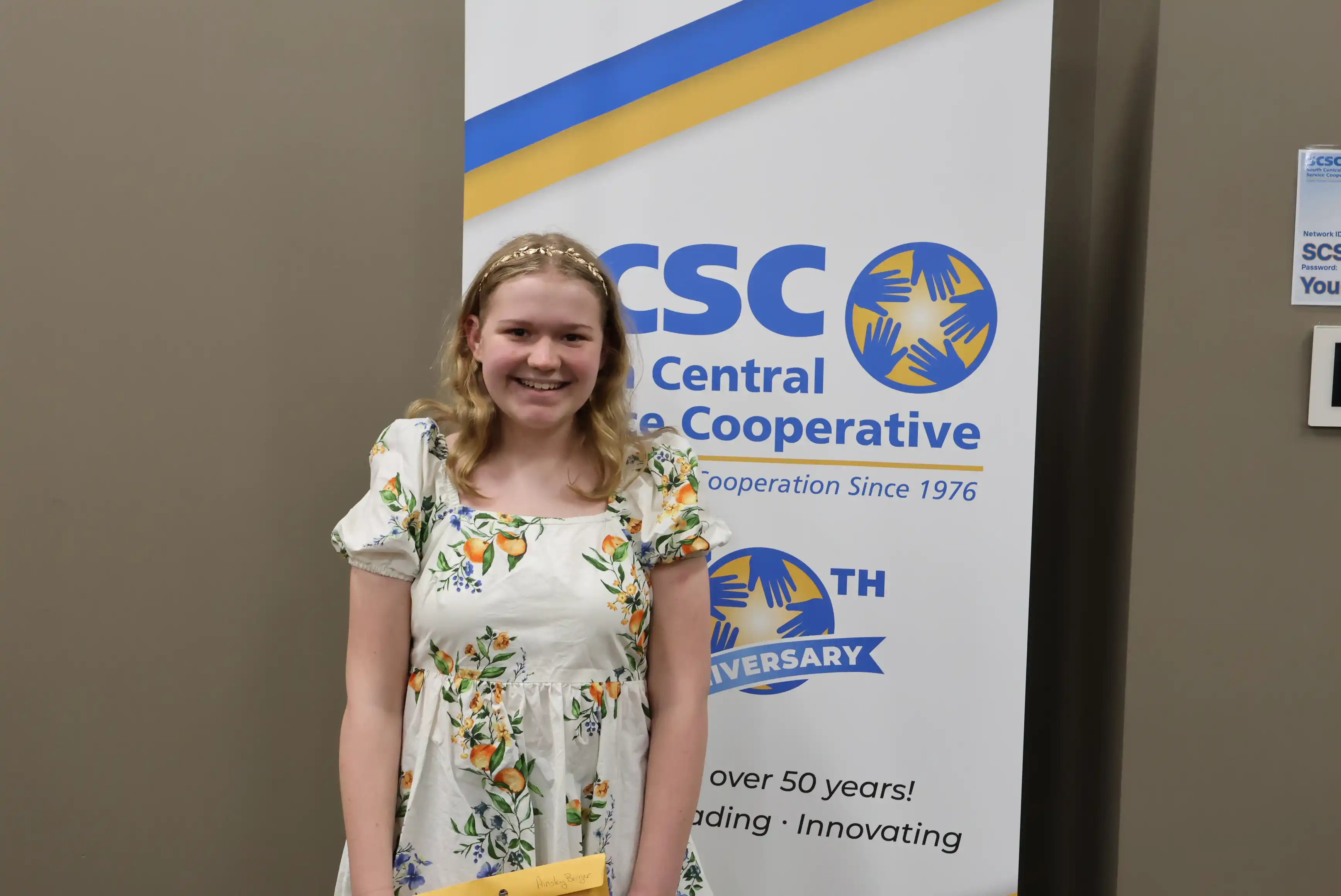SCSC Writing Student Contestant standing with their award certificate