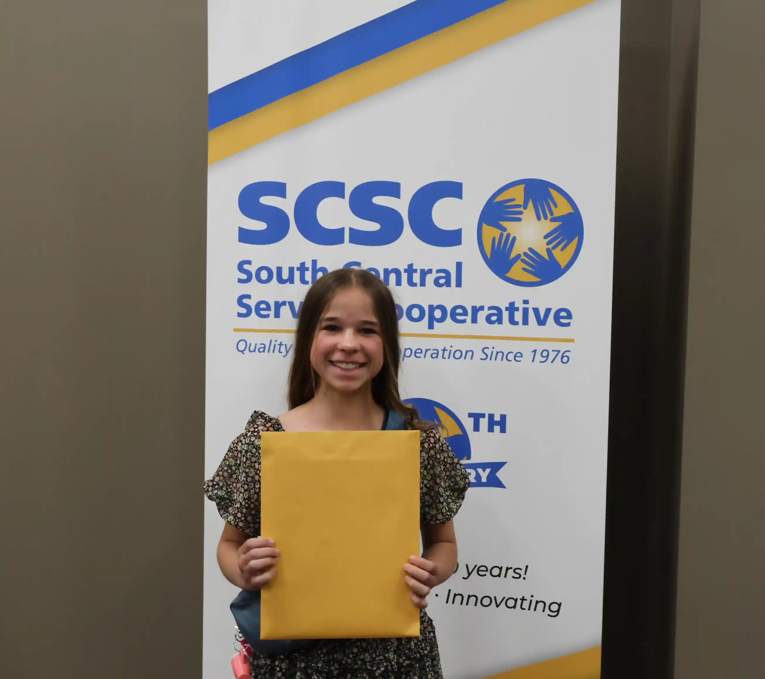 SCSC Writing Student Contestant standing with their award certificate