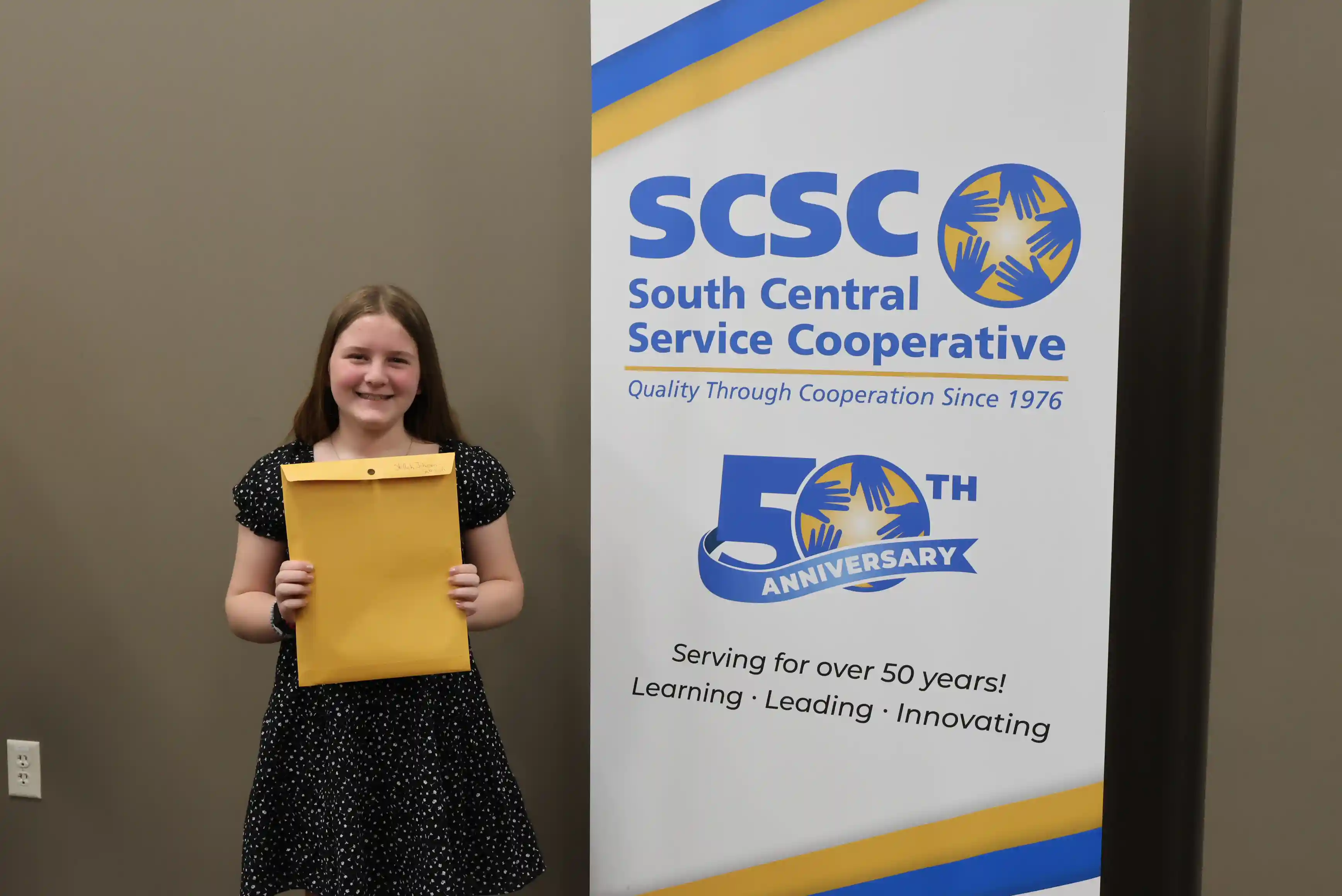SCSC Writing Student Contestant standing with their award certificate