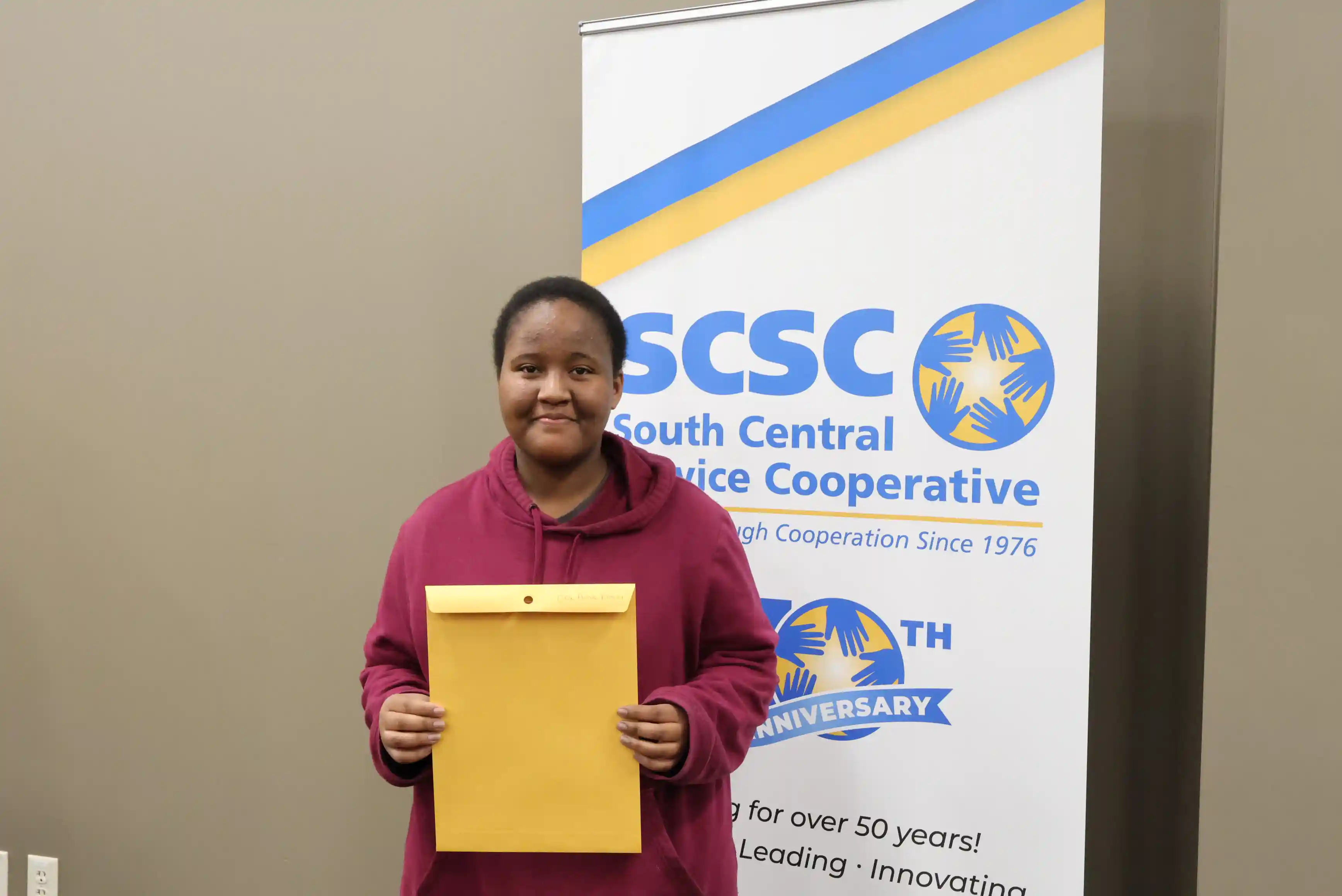 SCSC Writing Student Contestant standing with their award certificate