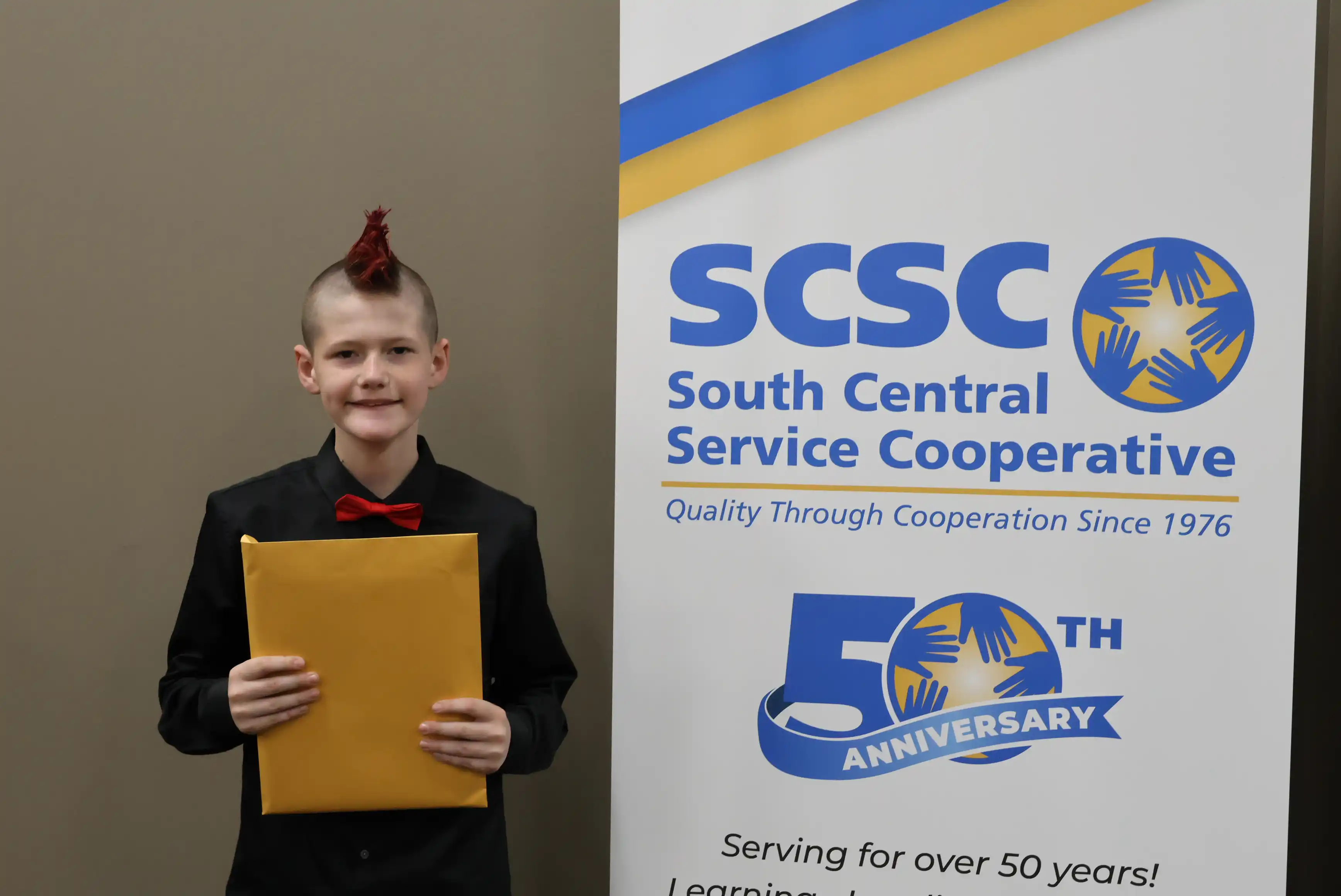 SCSC Writing Student Contestant standing with their award certificate