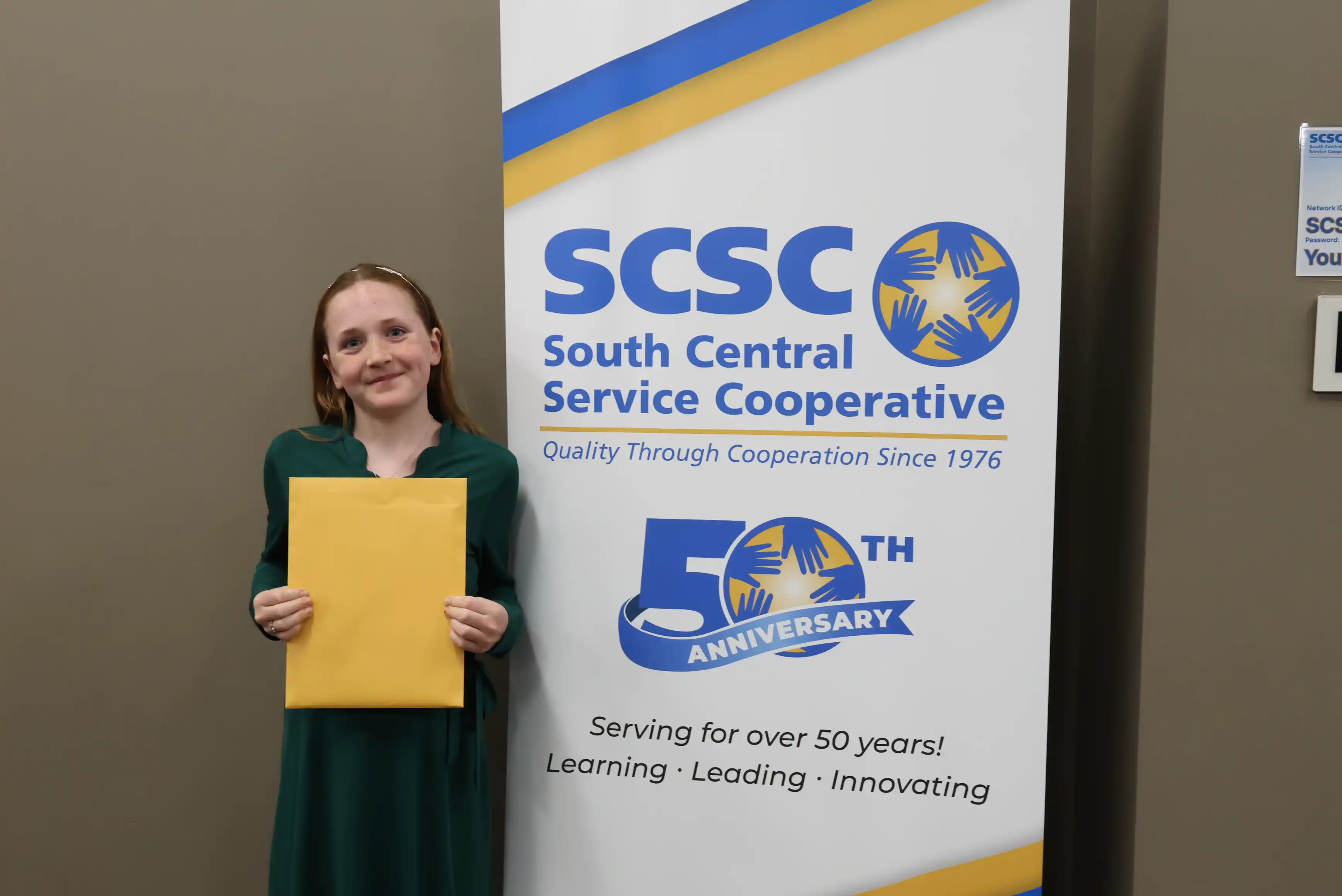 SCSC Writing Student Contestant standing with their award certificate