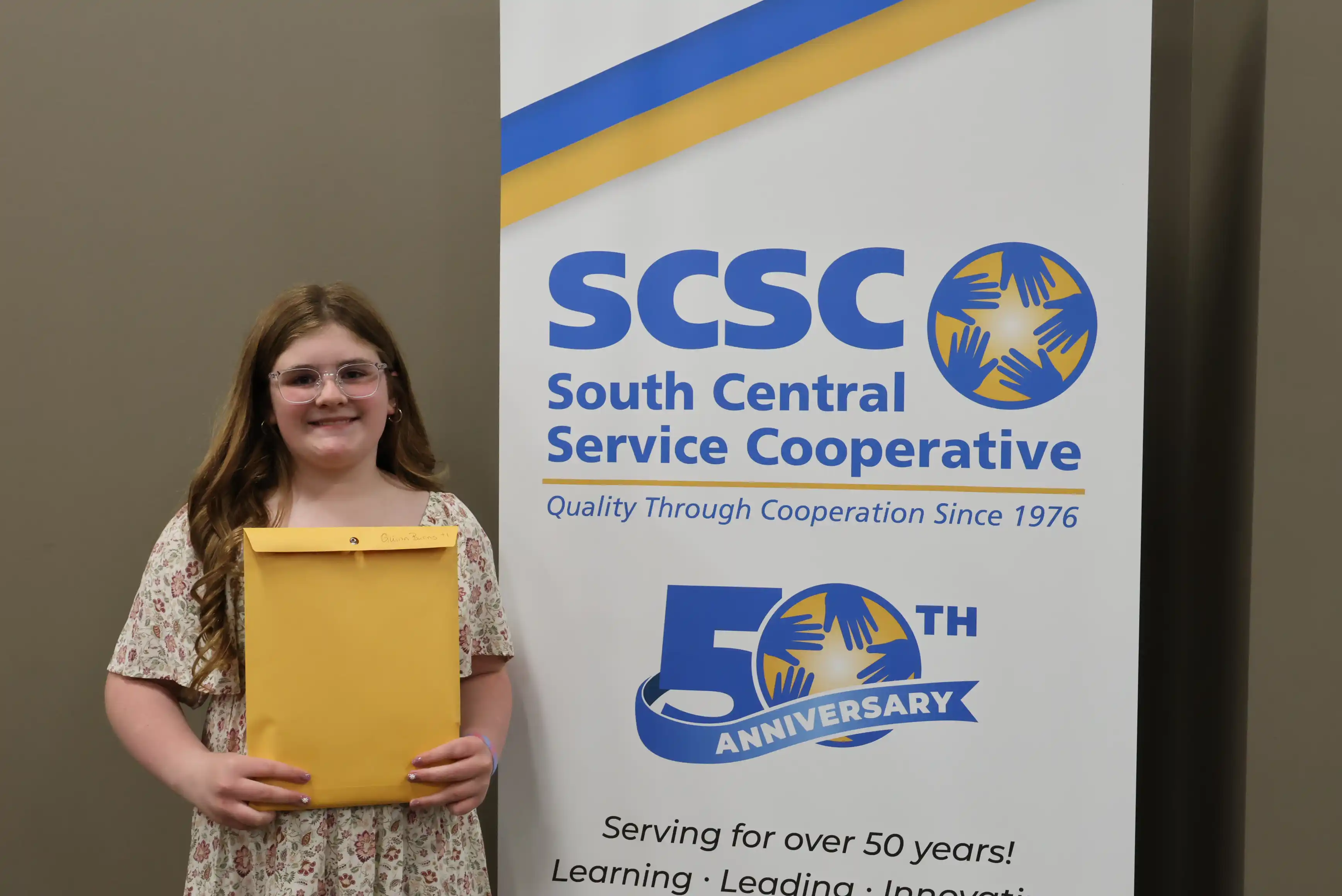 SCSC Writing Student Contestant standing with their award certificate