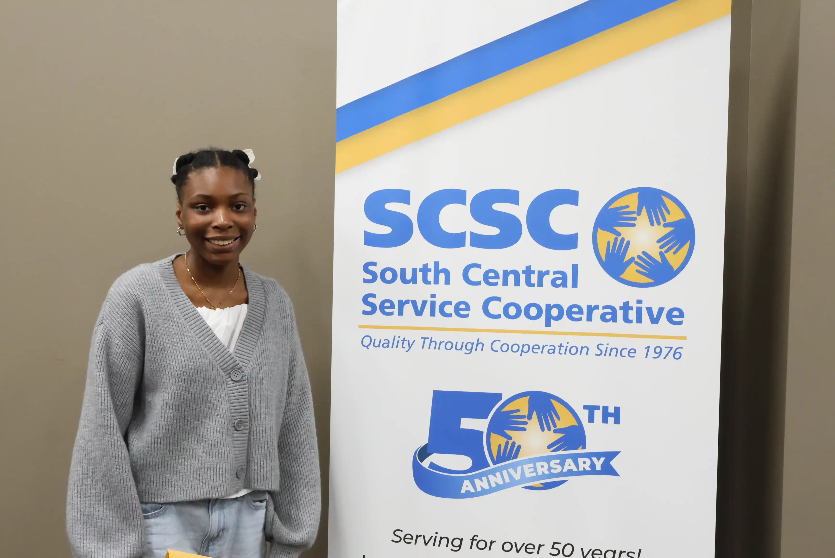 SCSC Writing Student Contestant standing with their award certificate