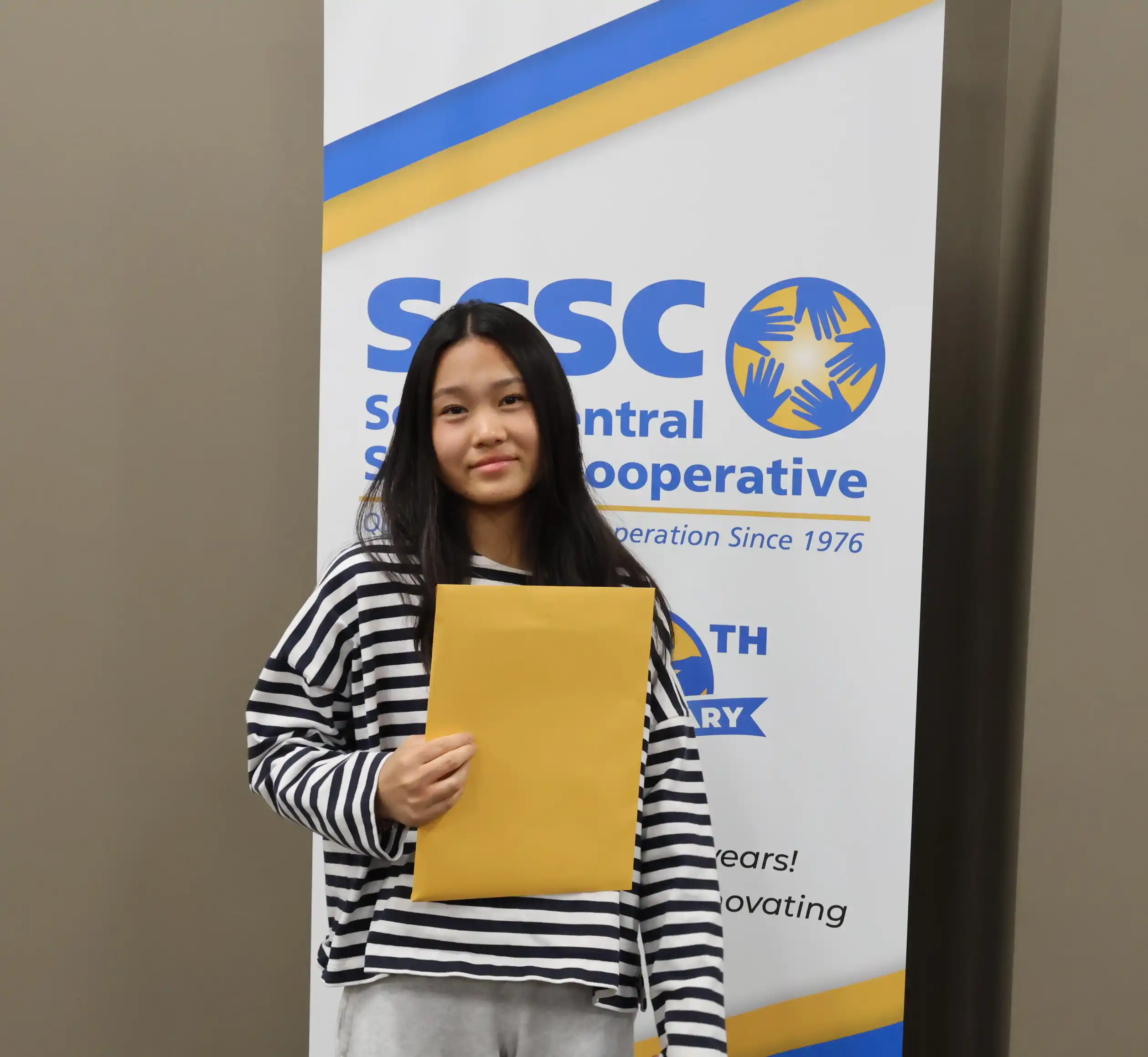 SCSC Writing Student Contestant standing with their award certificate
