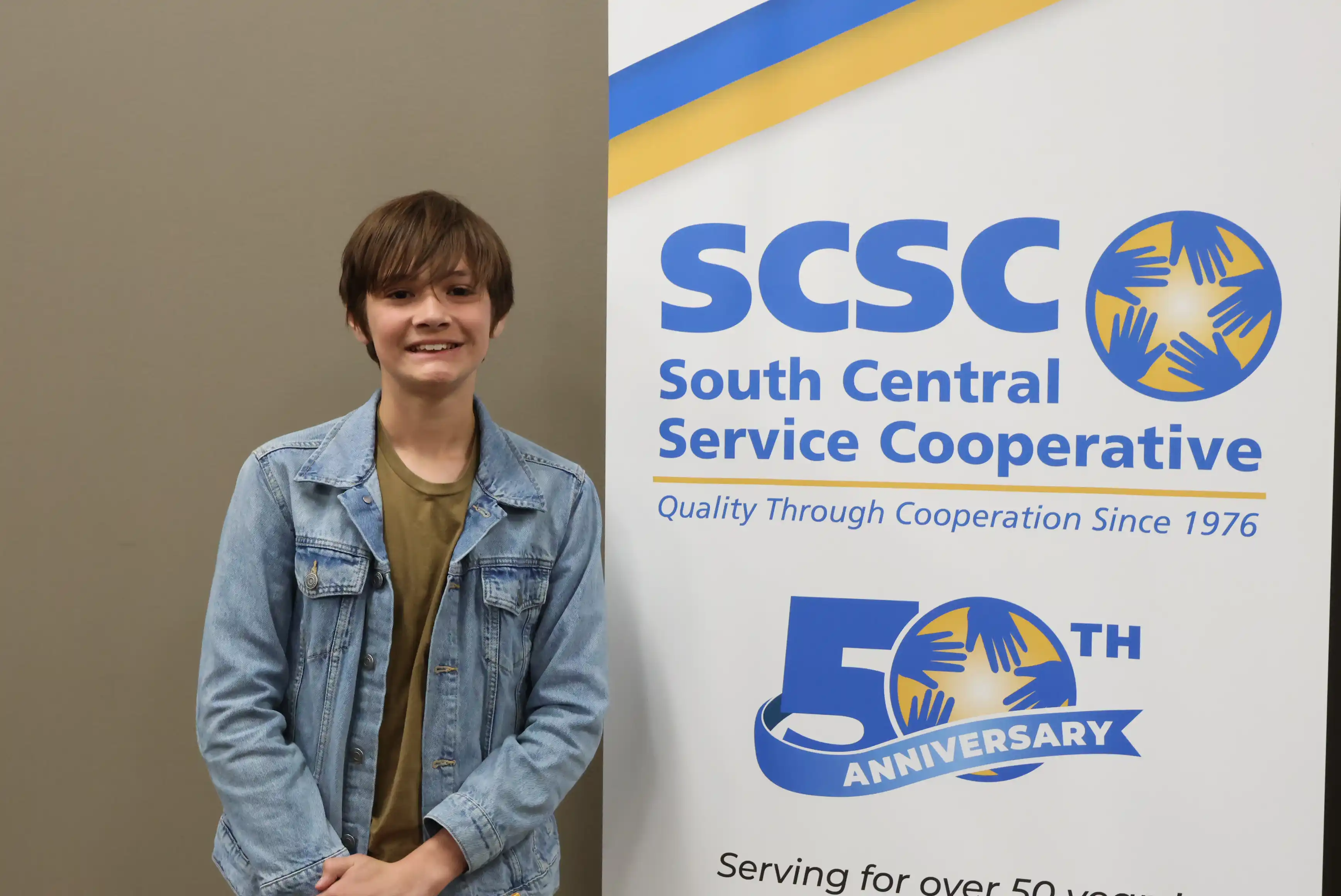 SCSC Writing Student Contestant standing with their award certificate