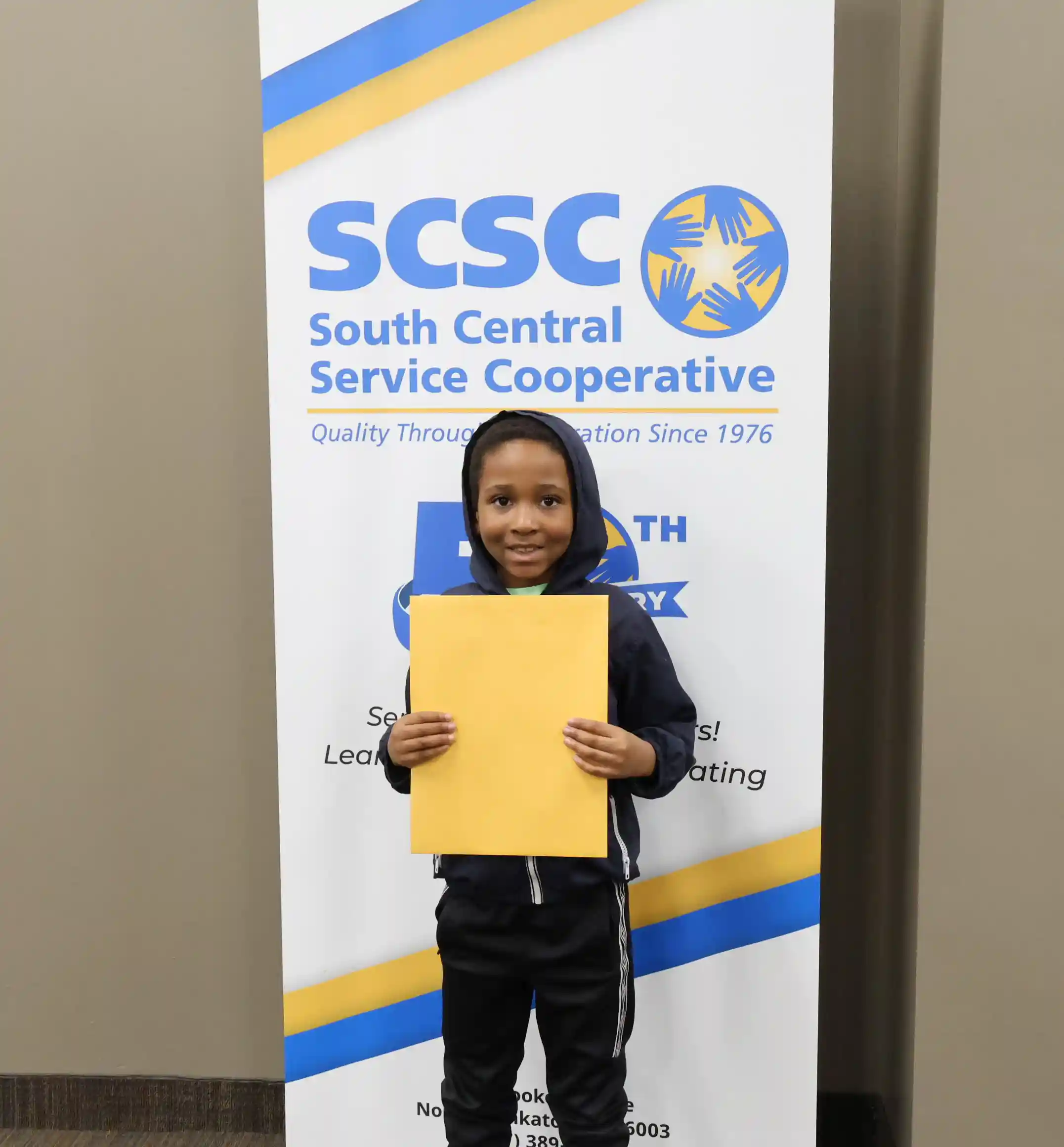 SCSC Writing Student Contestant standing with their award certificate
