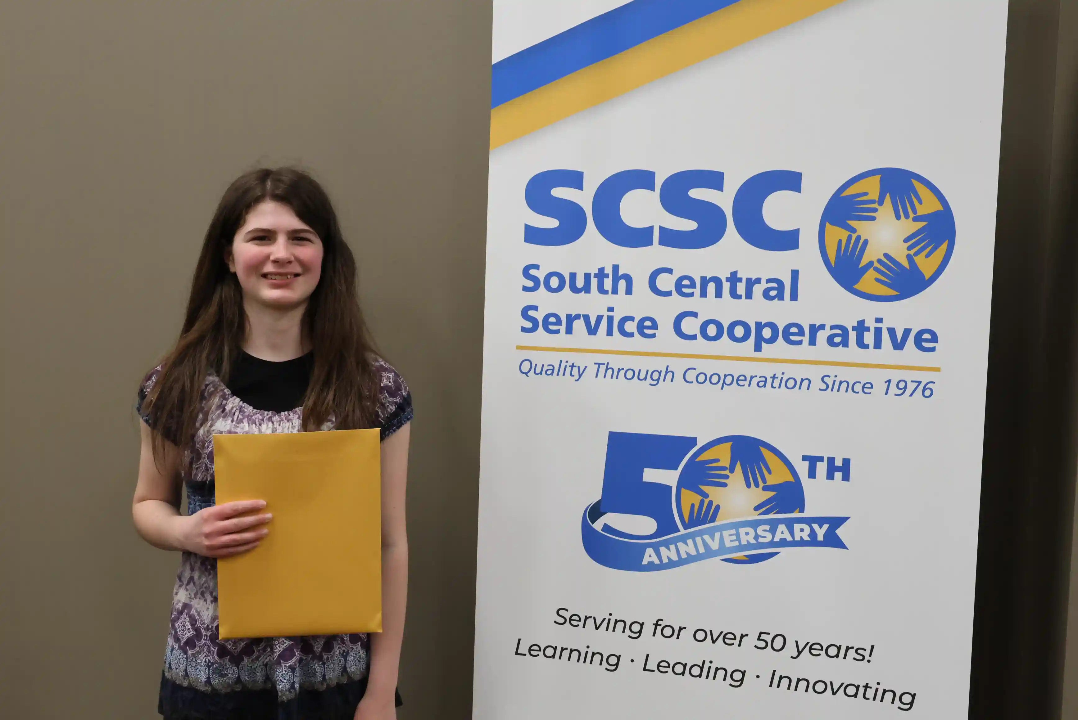 SCSC Writing Student Contestant standing with their award certificate