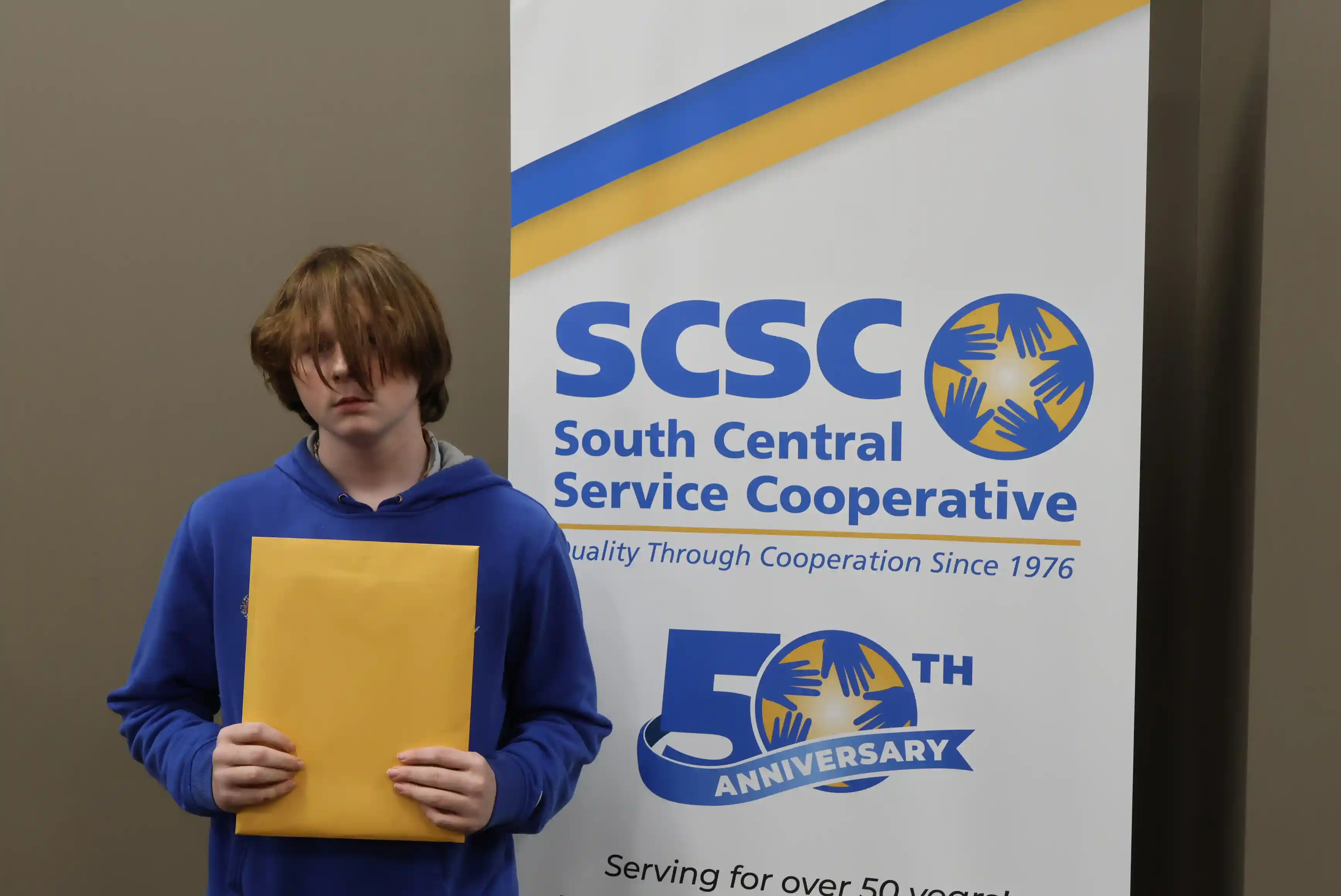 SCSC Writing Student Contestant standing with their award certificate