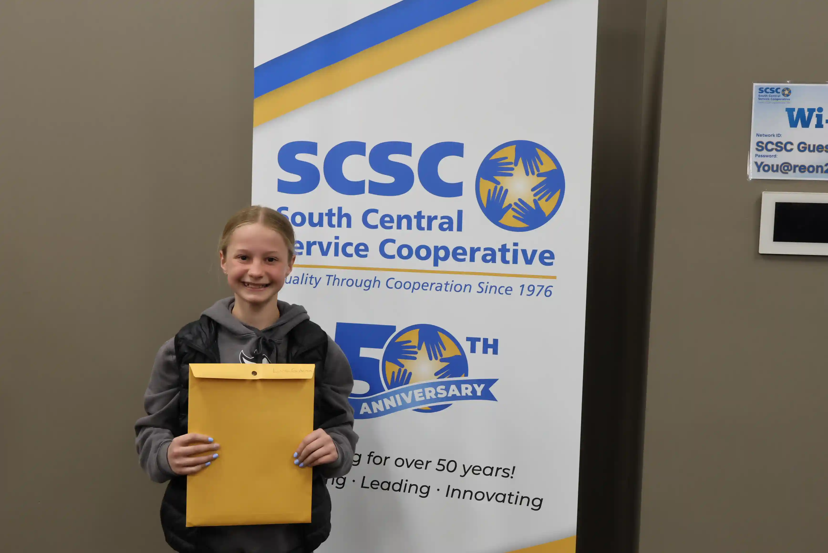 SCSC Writing Student Contestant standing with their award certificate