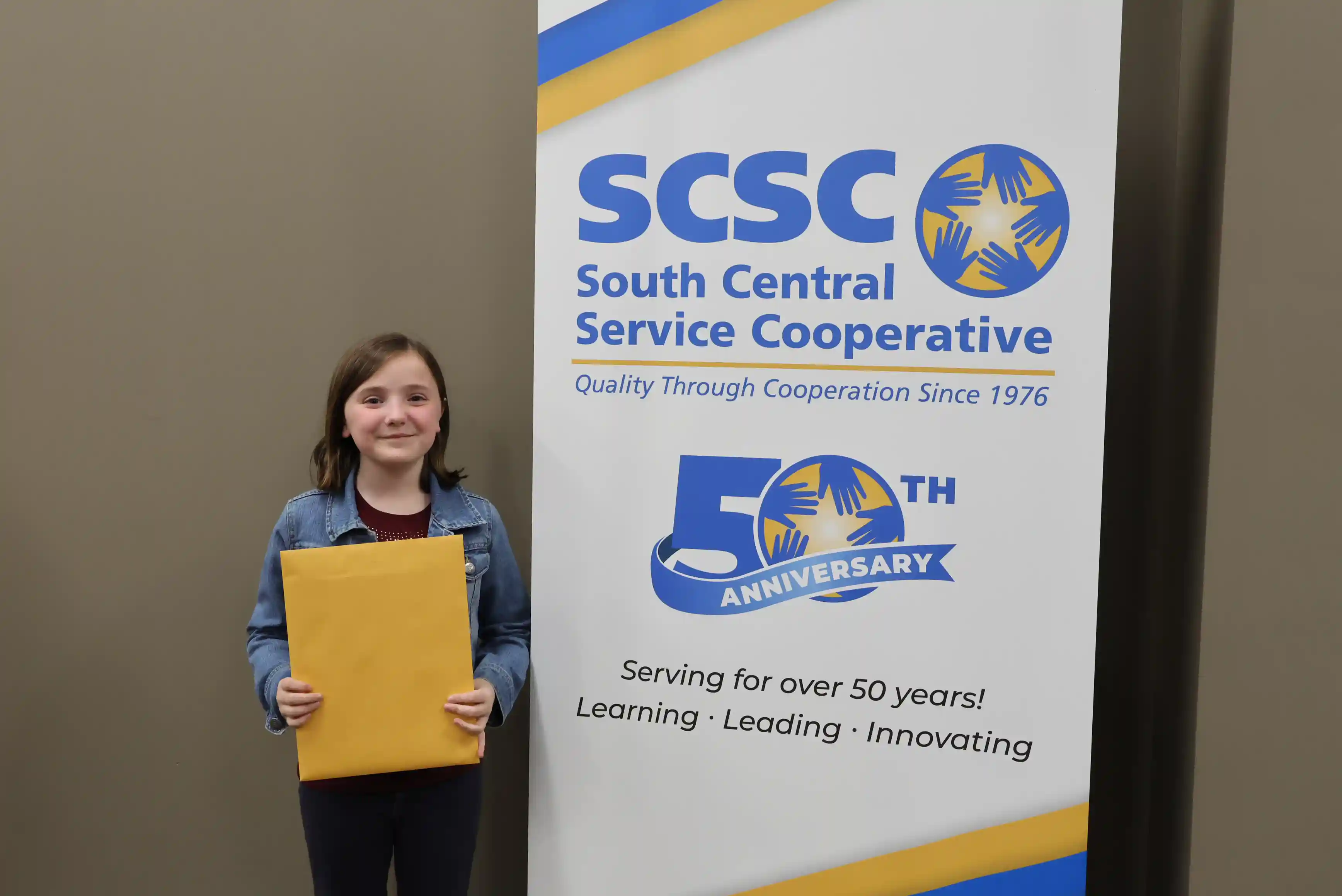 SCSC Writing Student Contestant standing with their award certificate