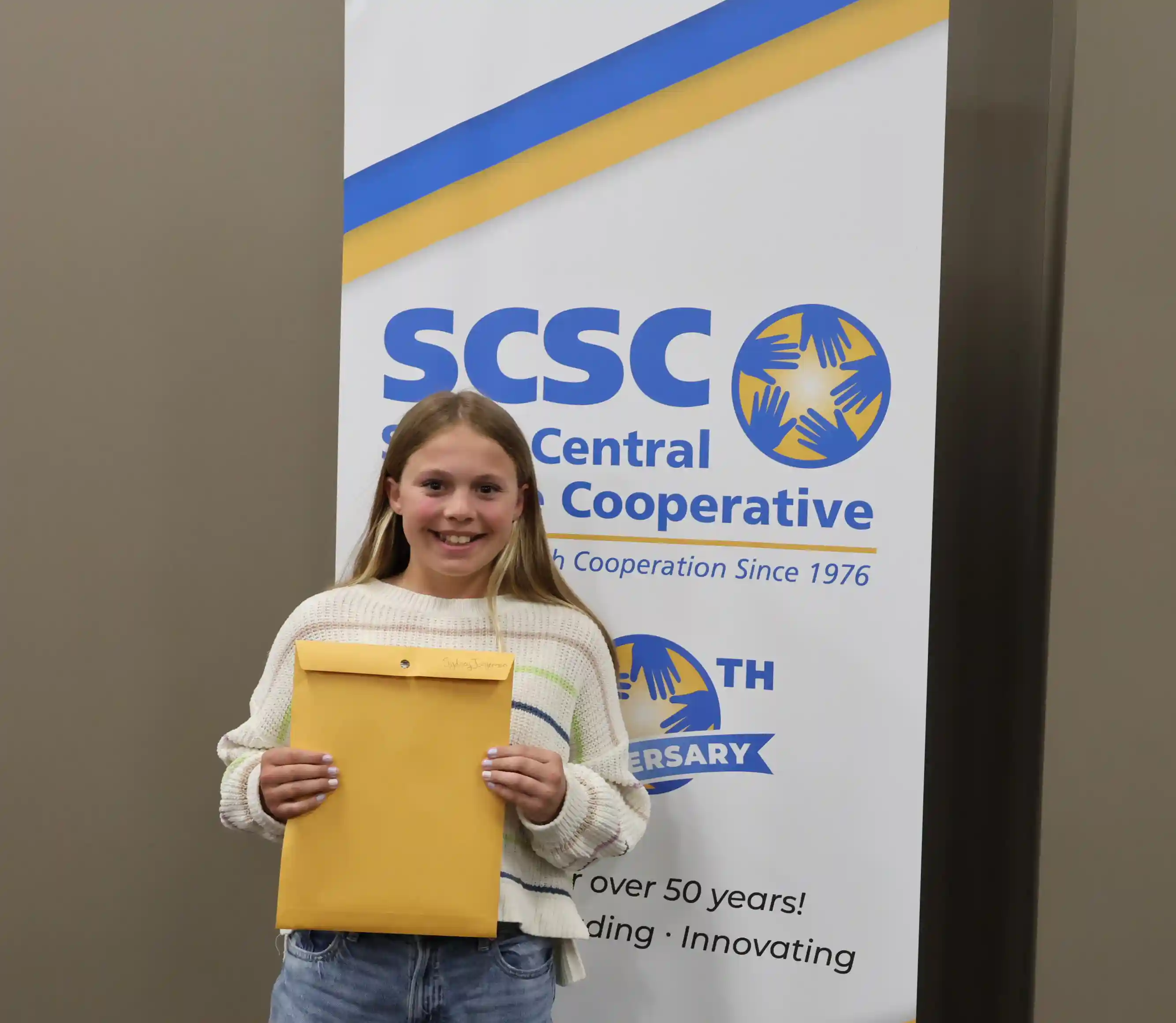 SCSC Writing Student Contestant standing with their award certificate