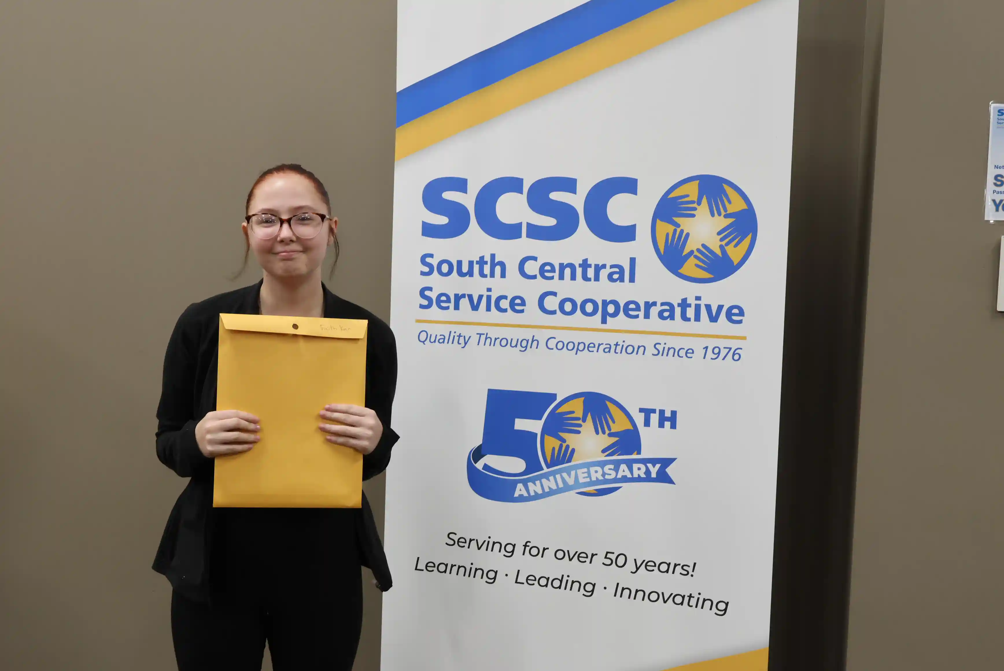 SCSC Writing Student Contestant standing with their award certificate