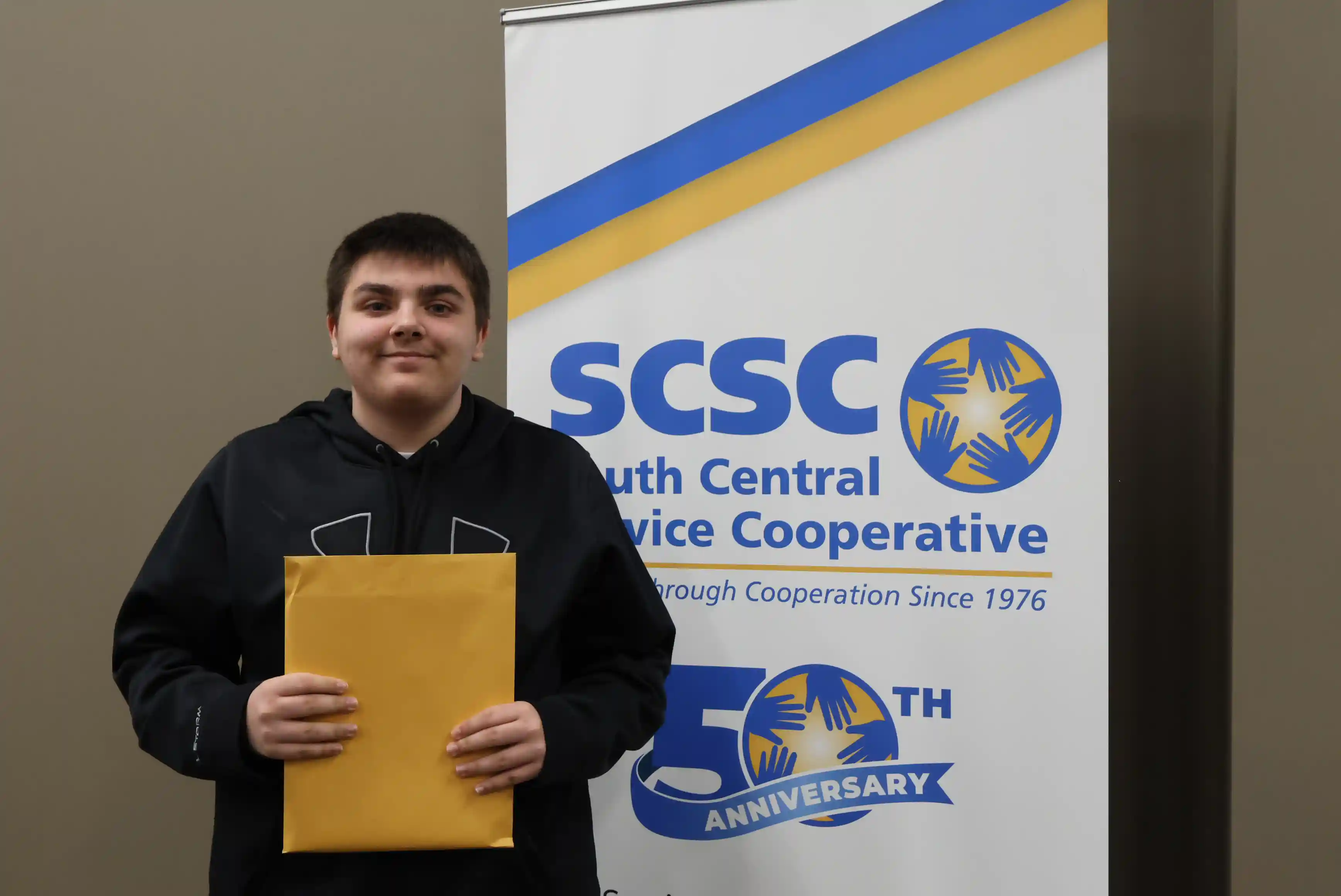 SCSC Writing Student Contestant standing with their award certificate