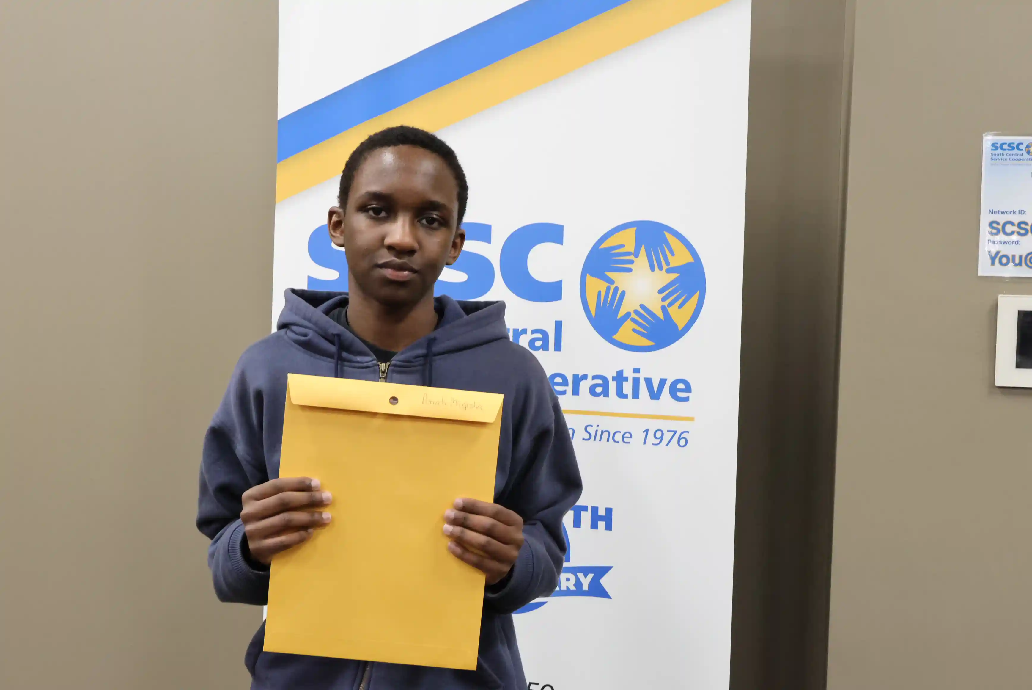 SCSC Writing Student Contestant standing with their award certificate