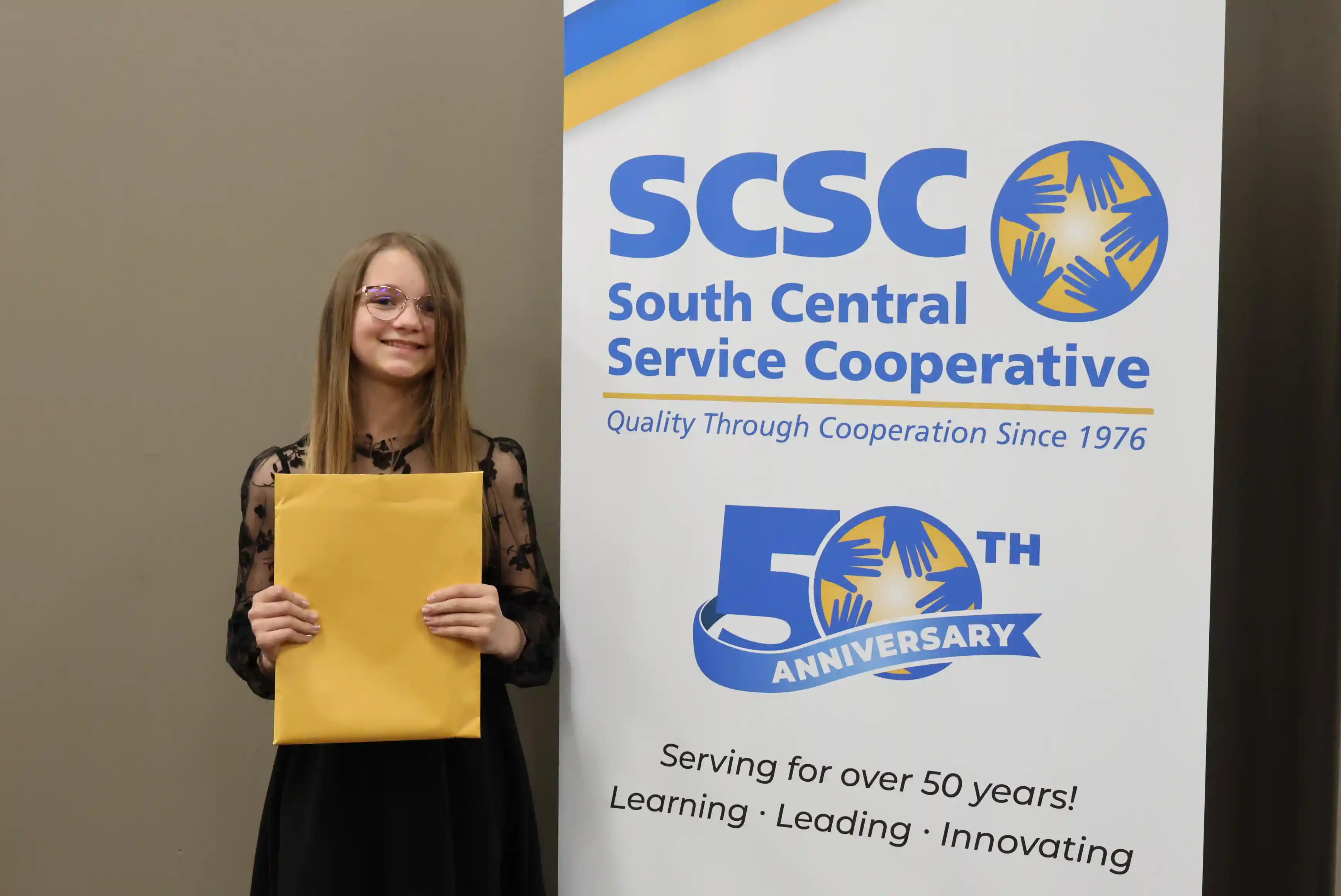 SCSC Writing Student Contestant standing with their award certificate