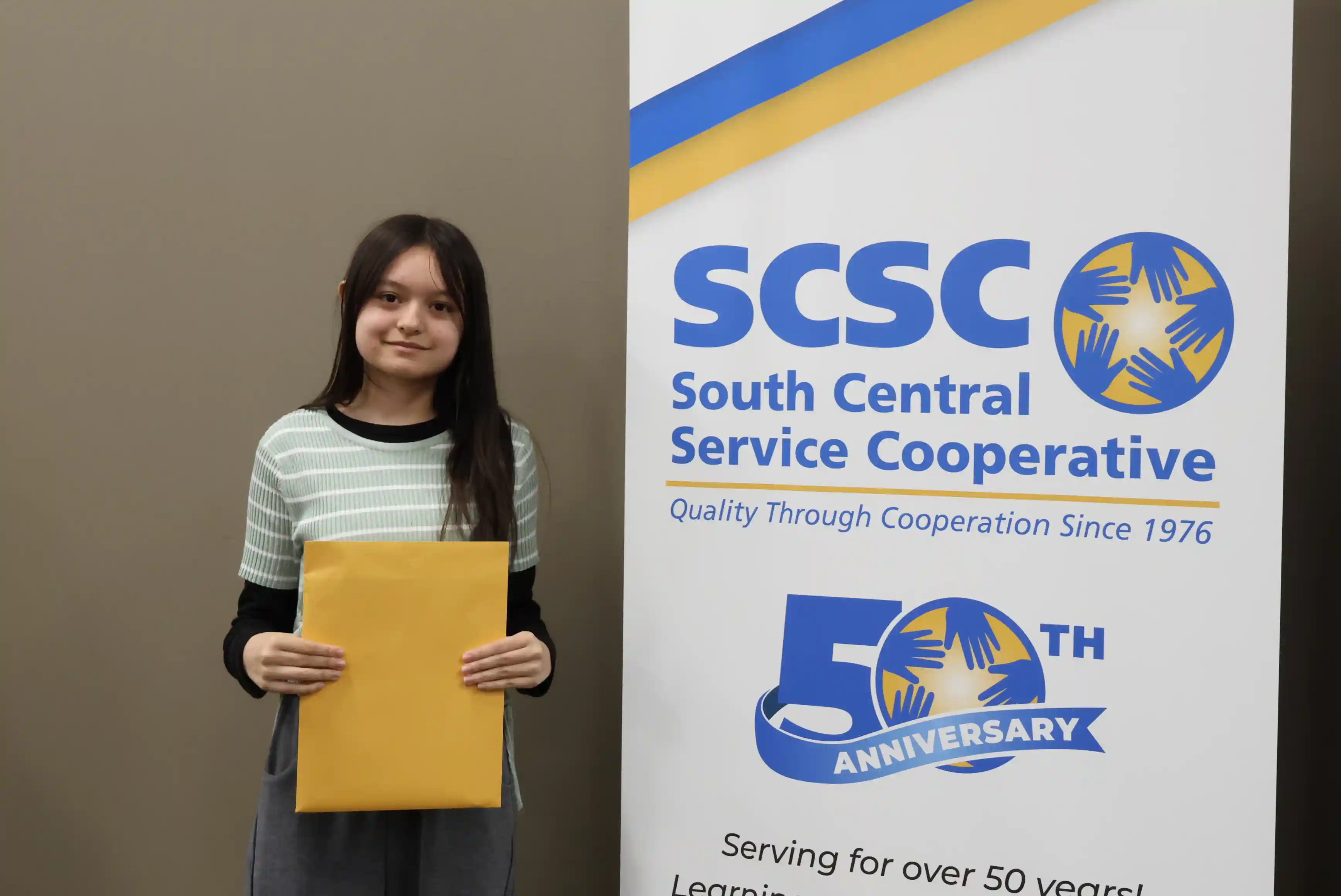 SCSC Writing Student Contestant standing with their award certificate