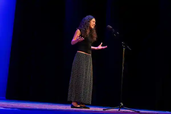 Sofia Skuza Rivera on stage reciting her poem