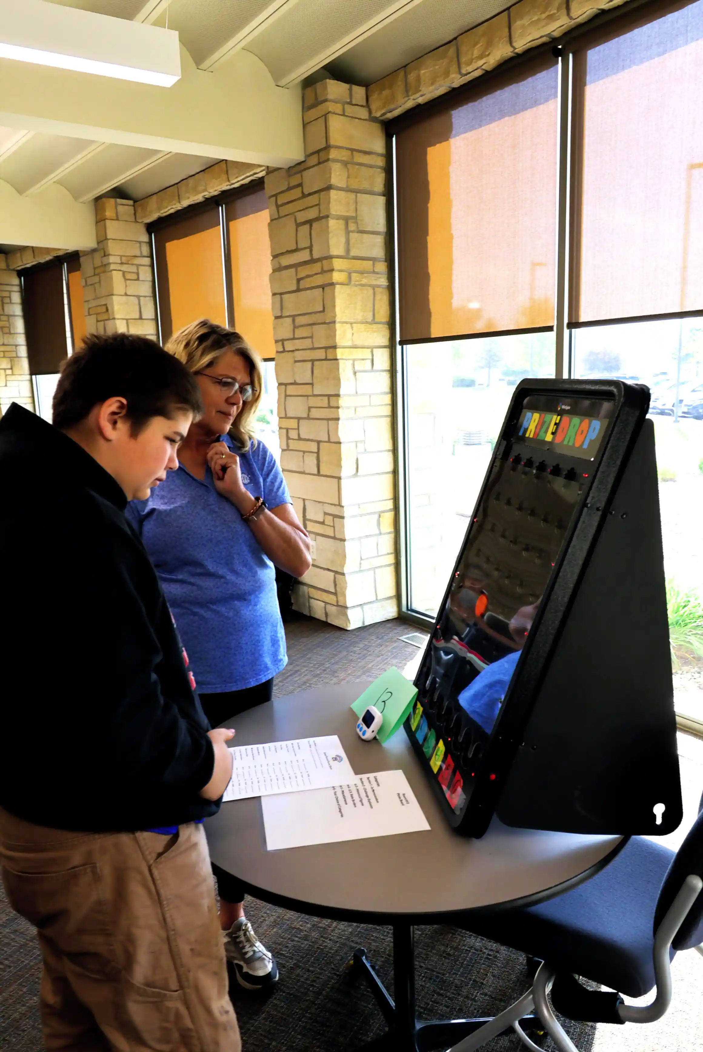 student working at table with an adult