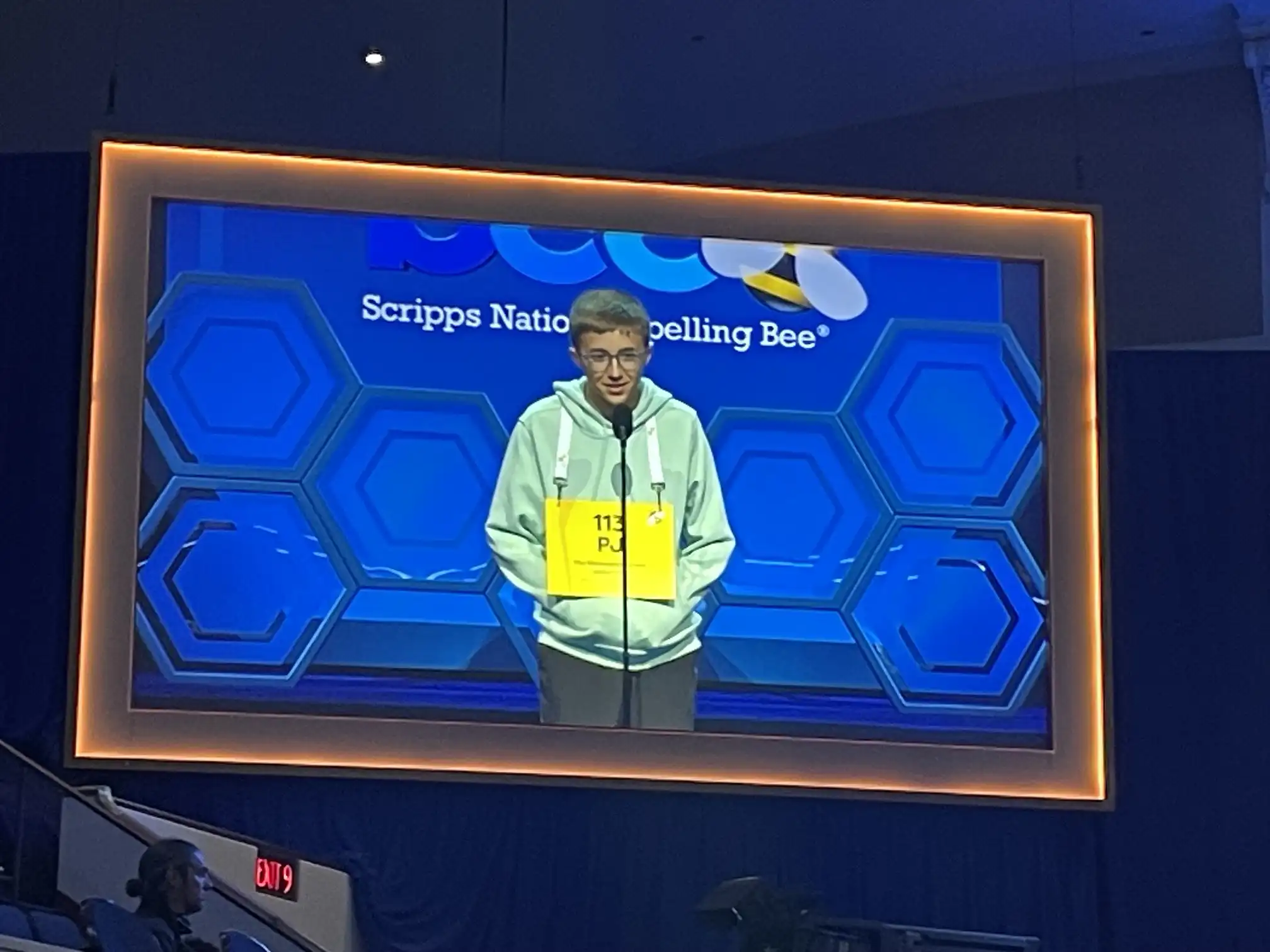 Student spelling competitor on stage