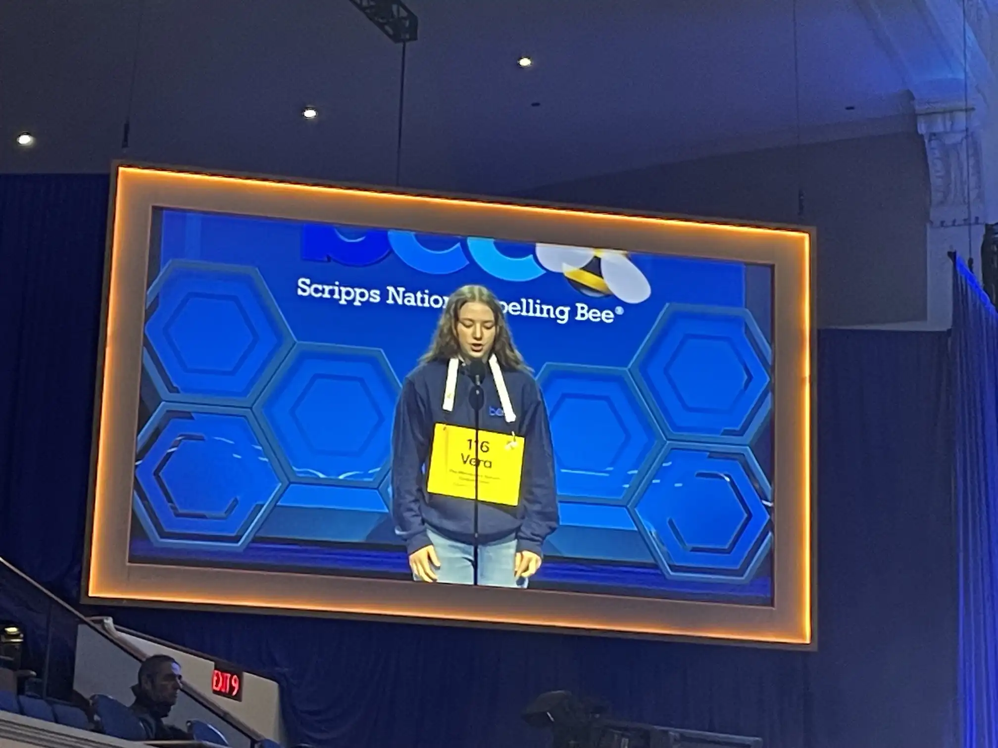 Student spelling competitor on stage