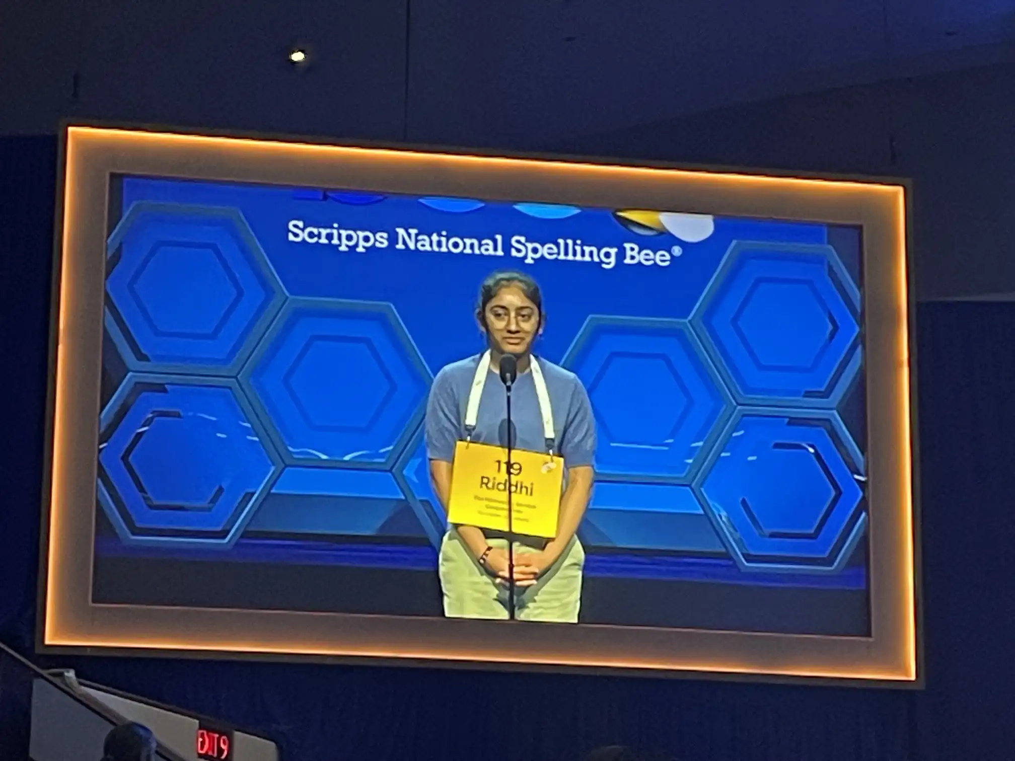 Student spelling competitor on stage