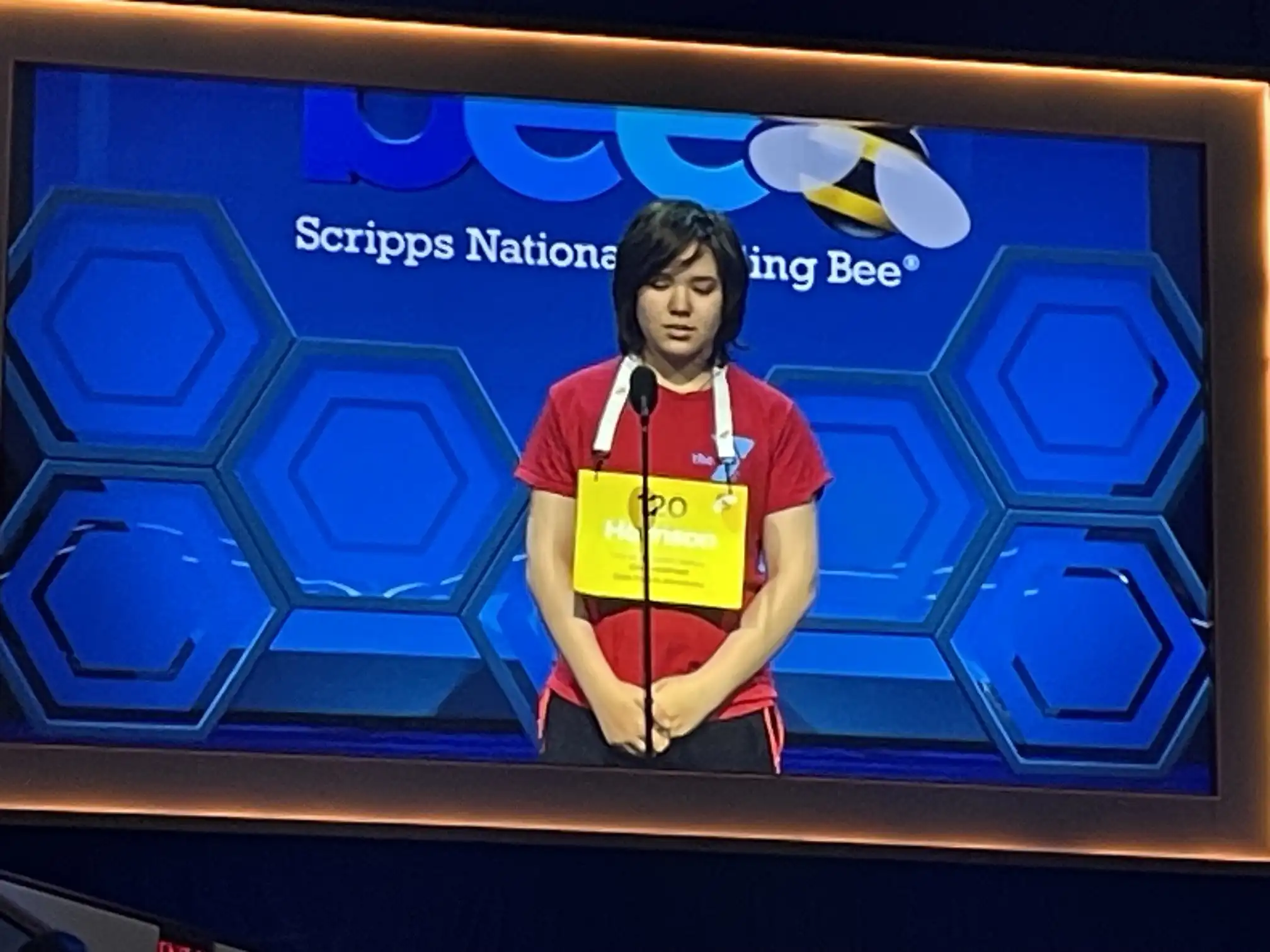 Student spelling competitor on stage
