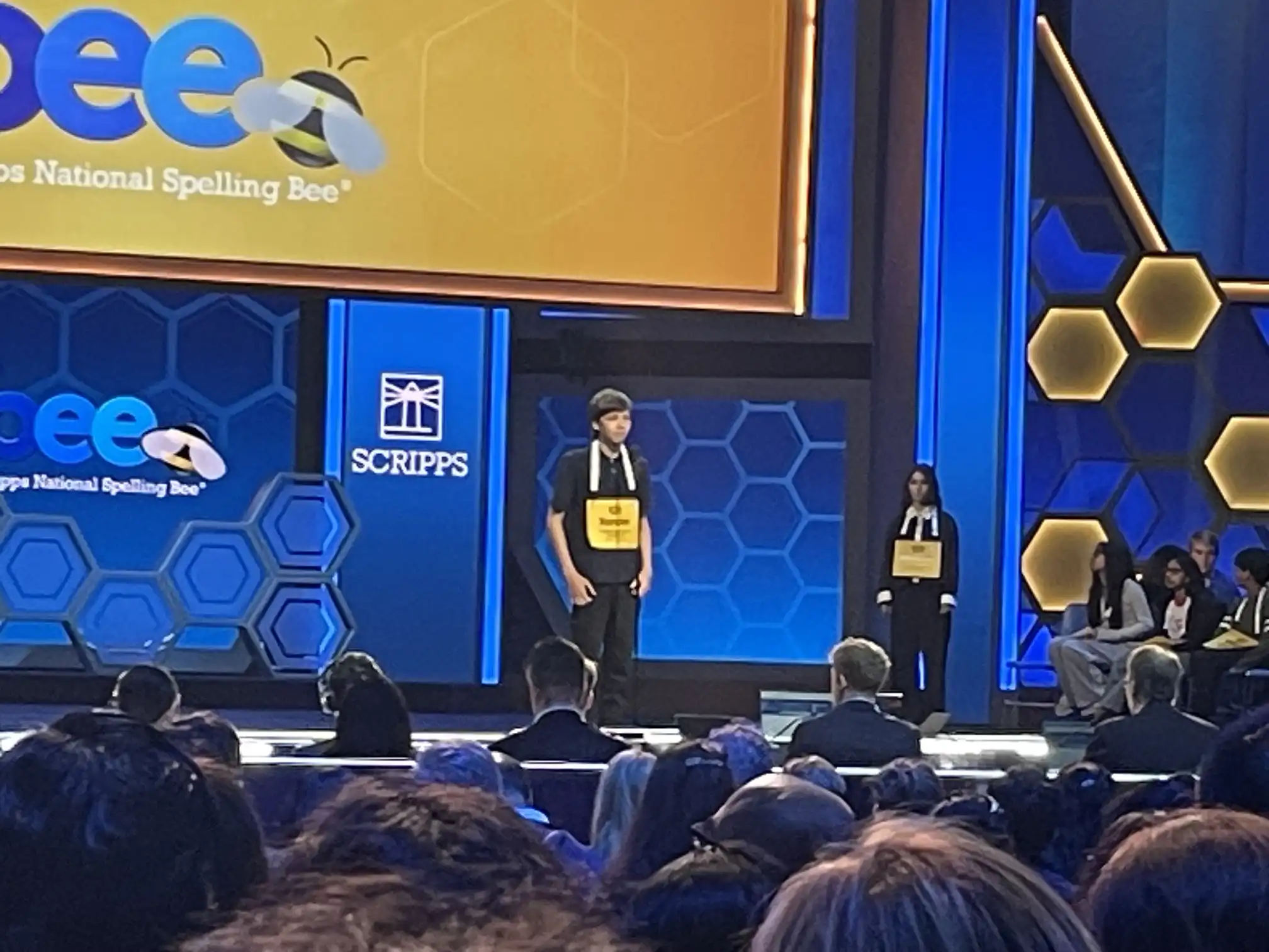 Student spelling competitor on stage