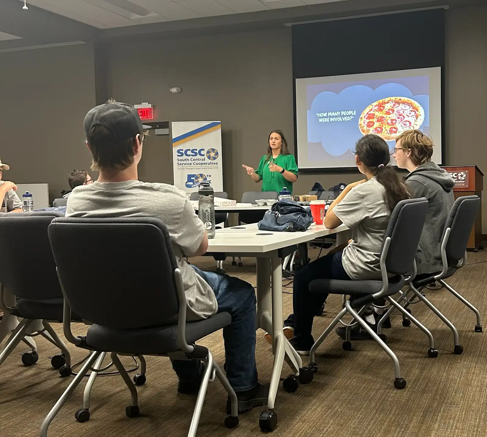 Students in a conference room listening to a presentation