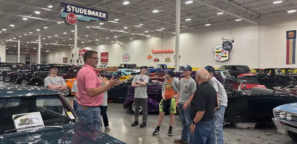 students looking at classic cars