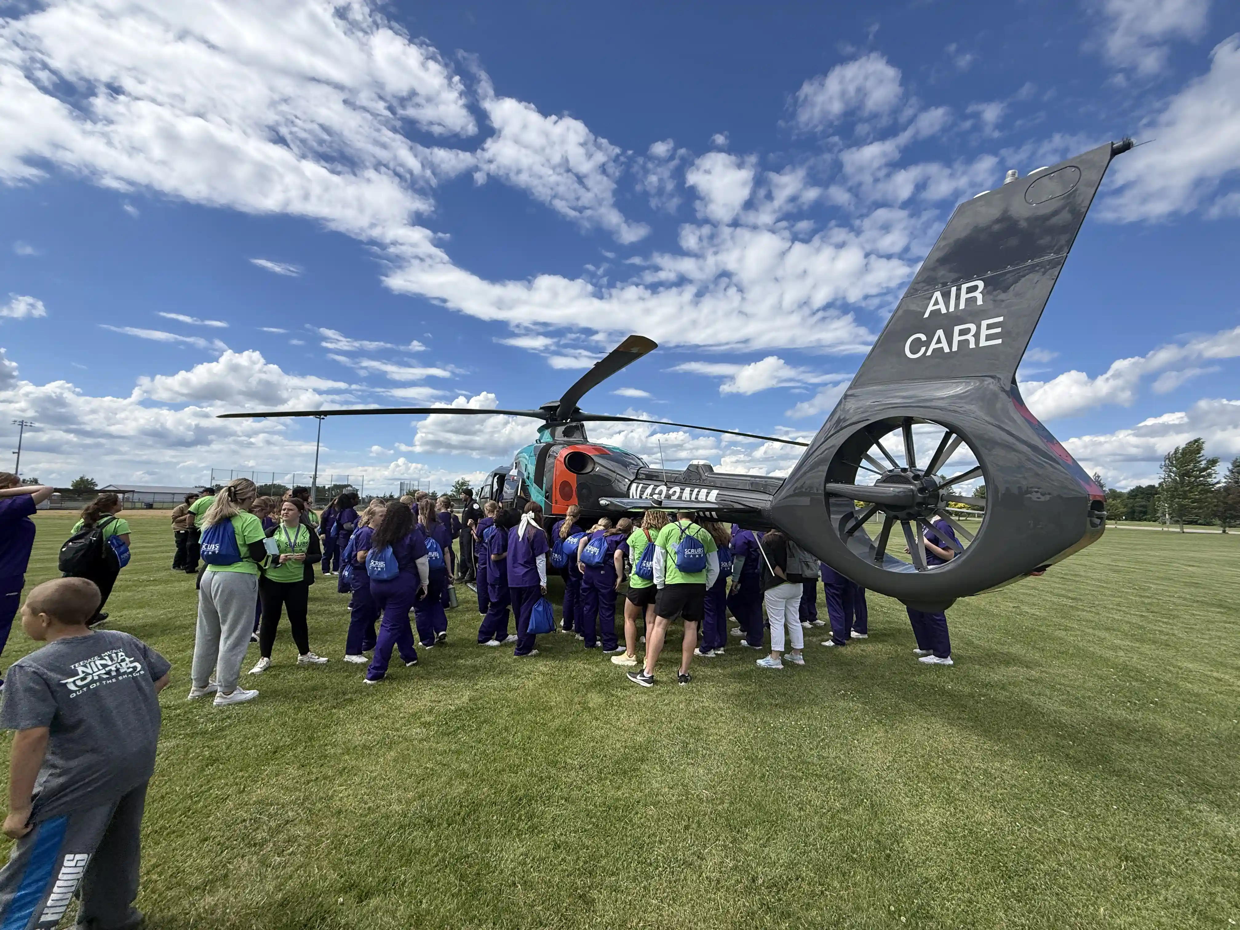 Students looking at a hospital medical helicopter