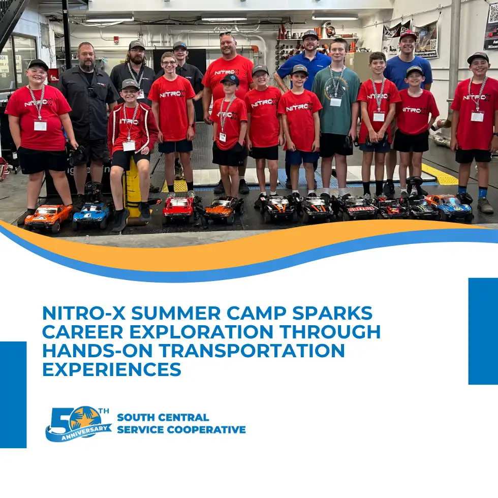 Camp attendees posing for a picture with their racing cars they built