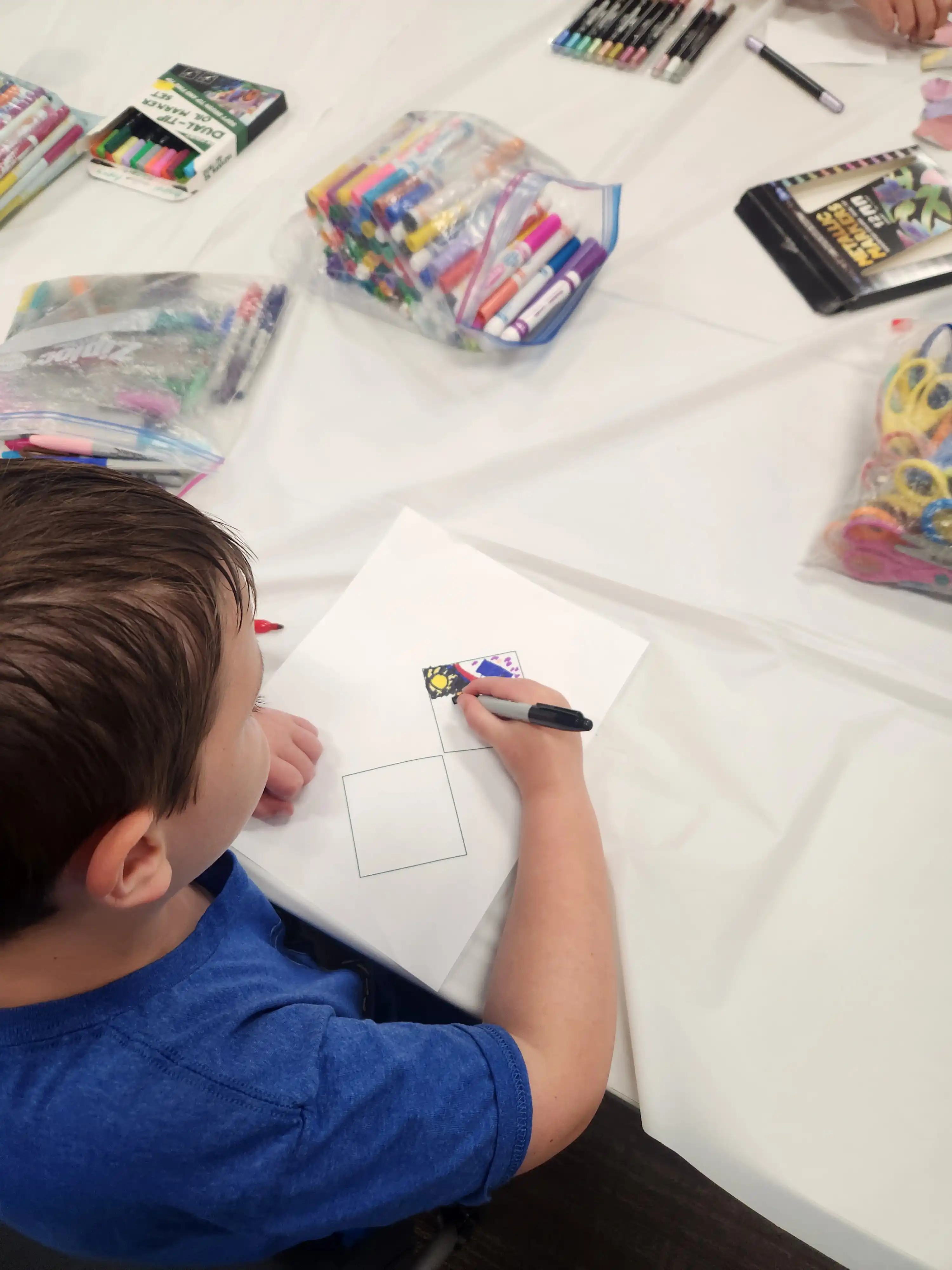 Student sitting at a table drawing