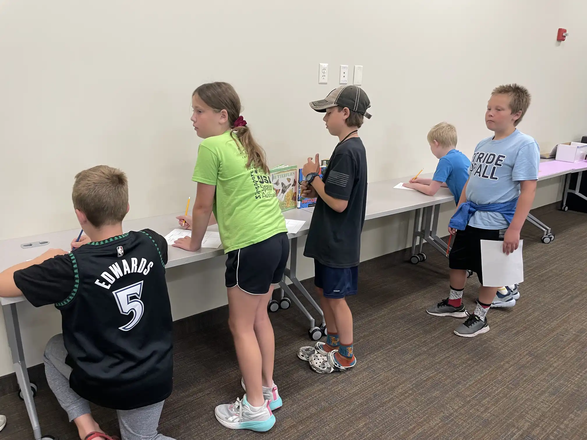 students standing in a group by a table
